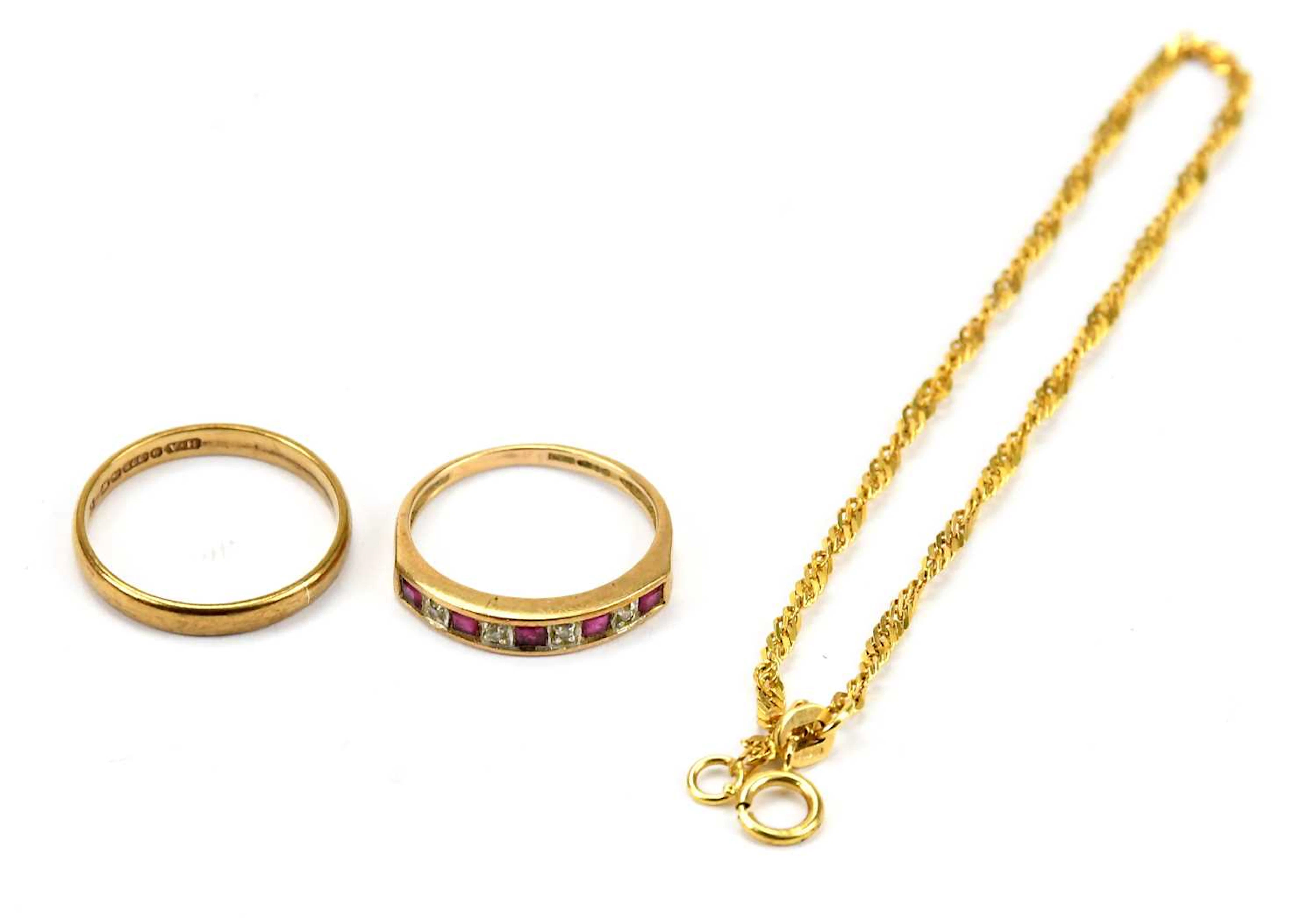A 9ct yellow gold ring set with diamond and red stone
