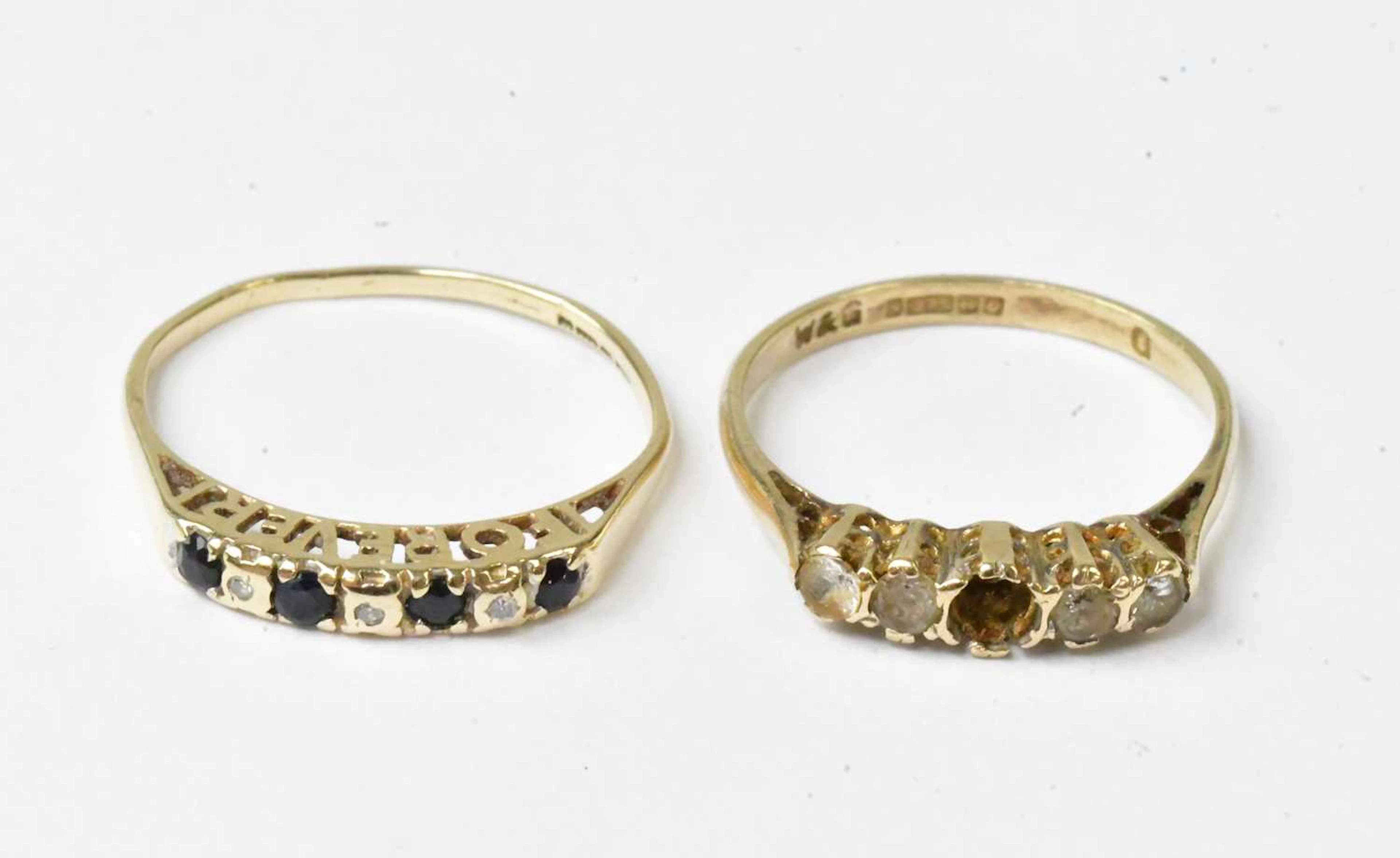 A 9ct yellow gold ring set with four blue stones and three tiny diamonds