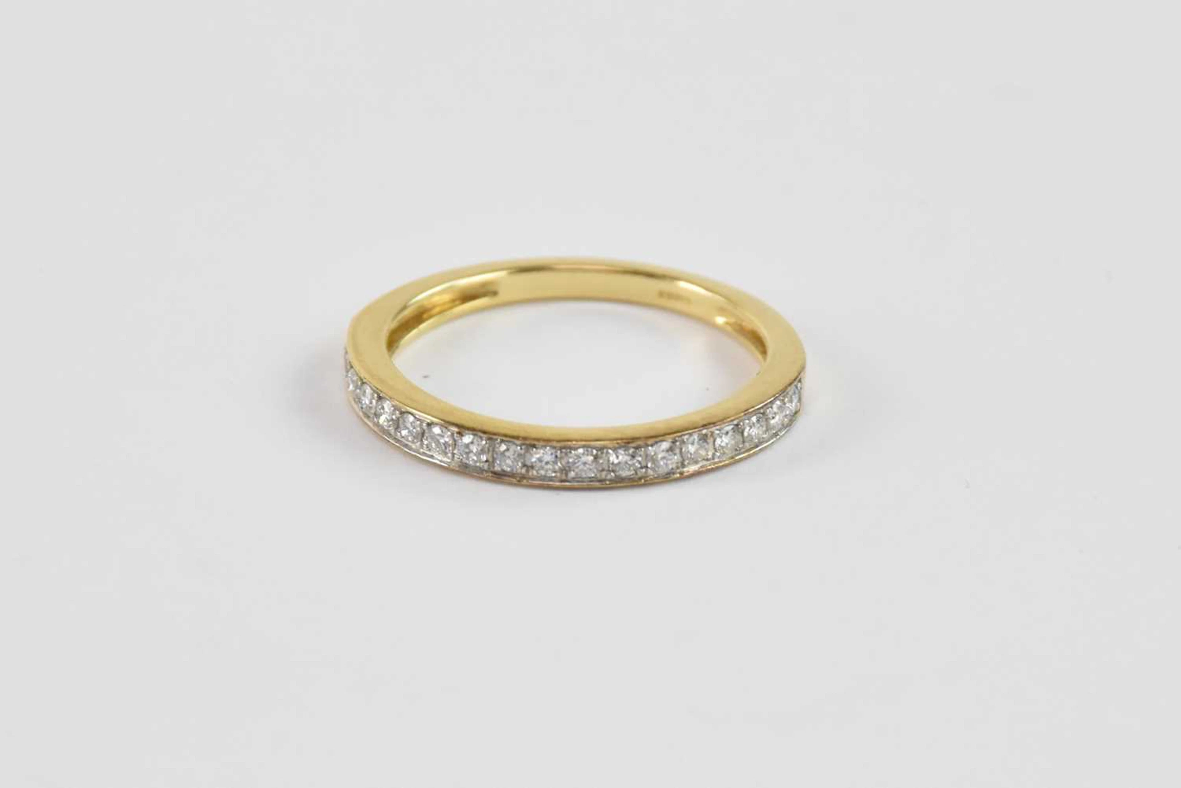 An 18ct yellow gold diamond half eternity ring