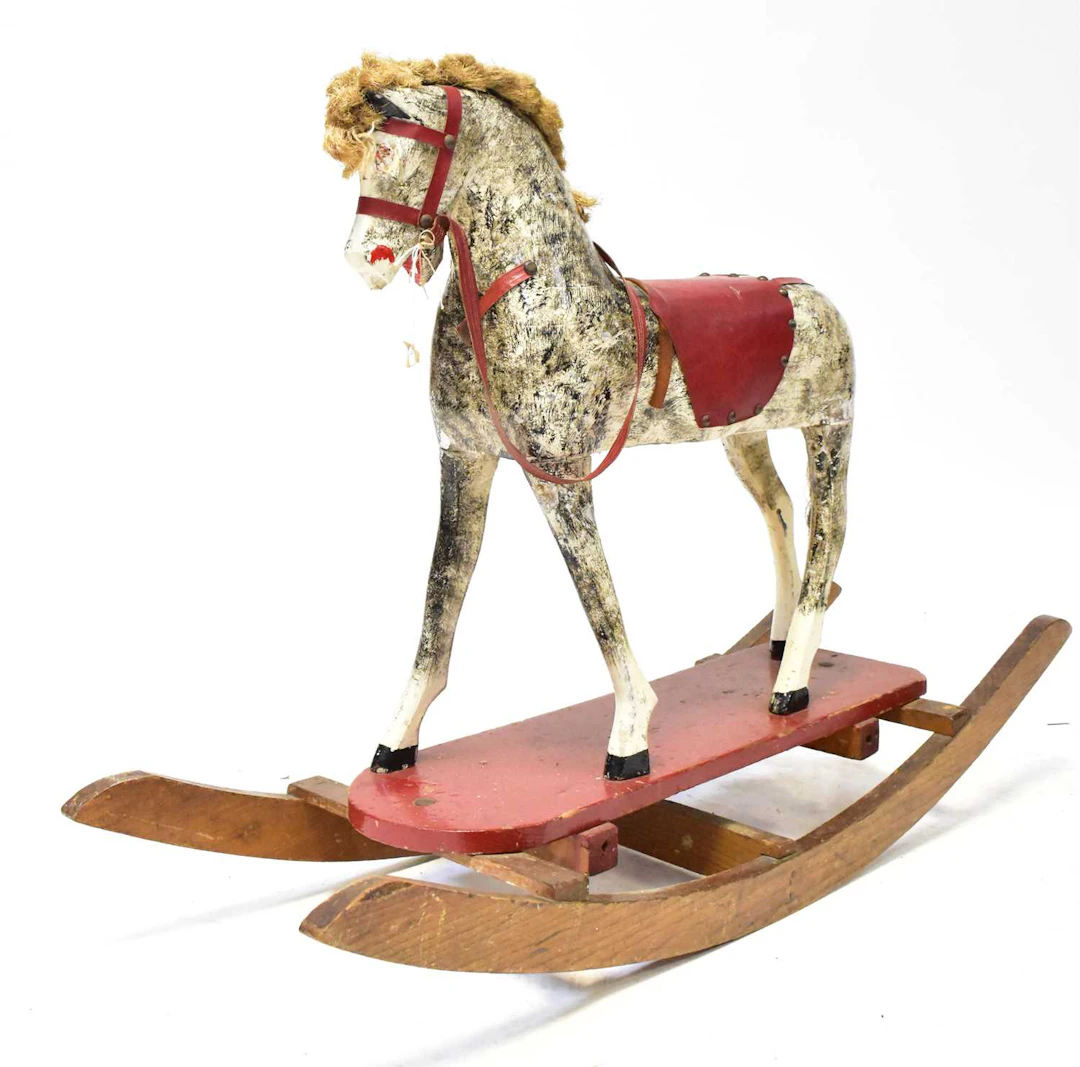 A late Victorian/Edwardian painted carved wooden bow rocker type rocking horse