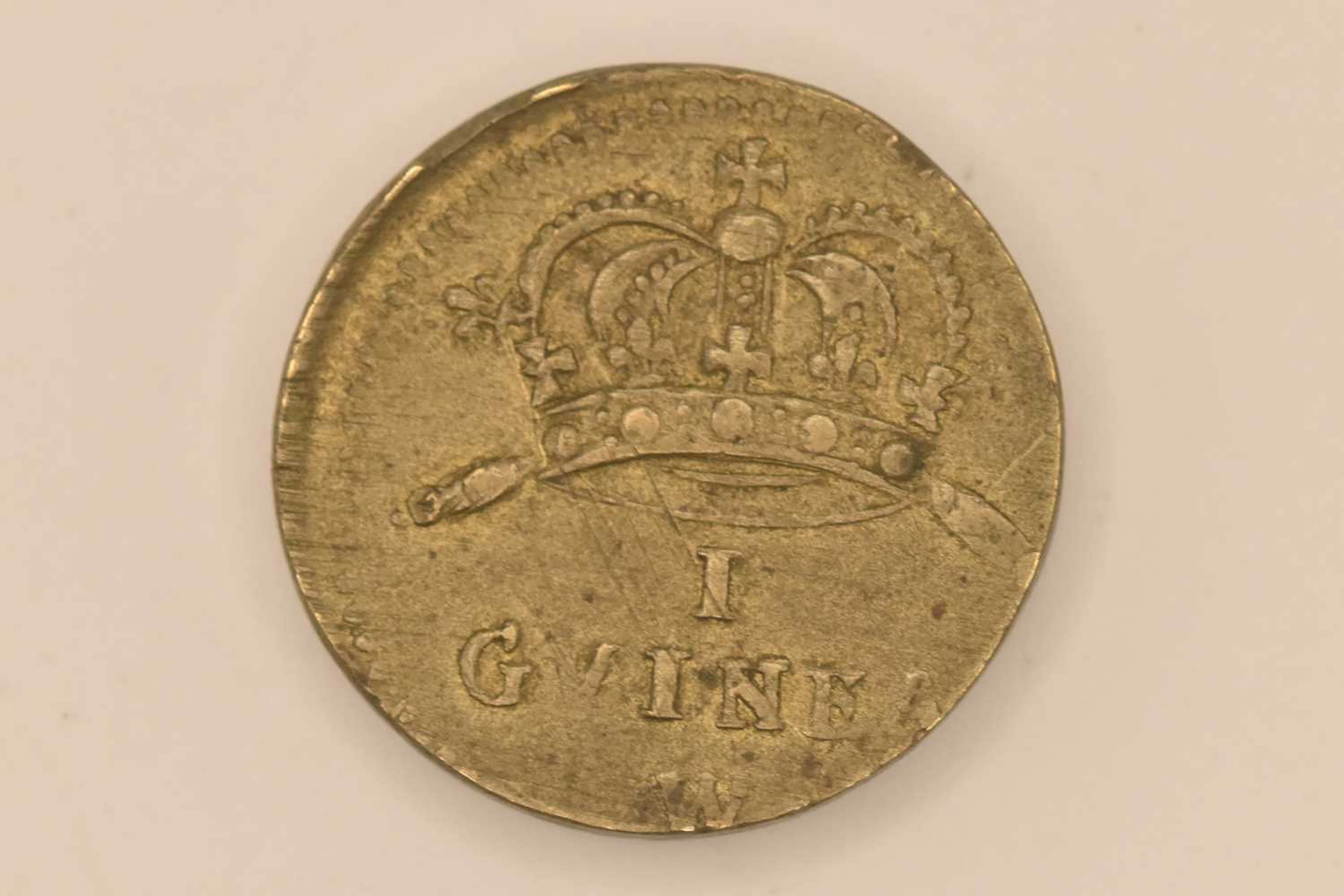 A one guinea brass coin weight