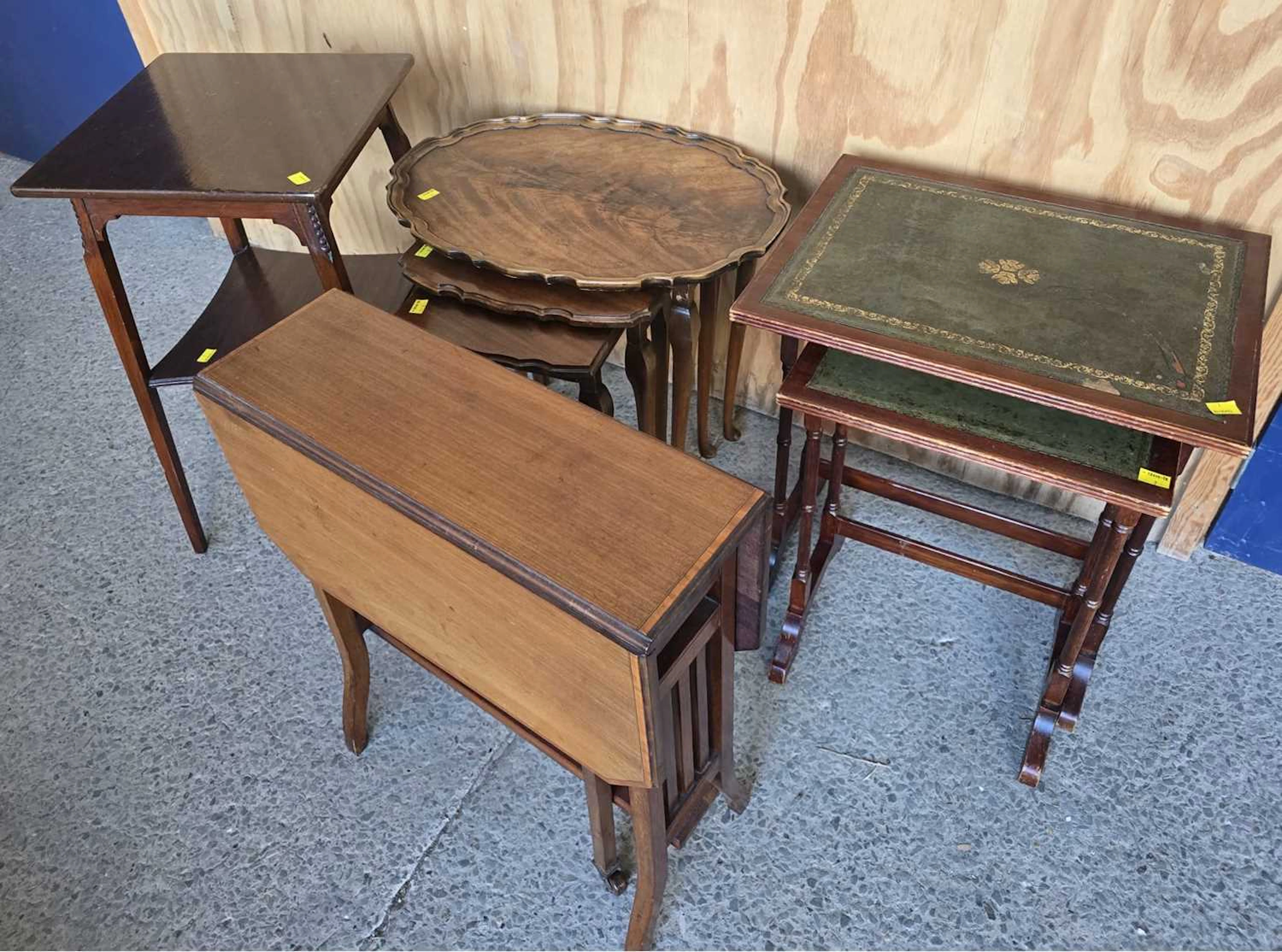 Four occasional side tables comprising a walnut veneered nest of three tables
