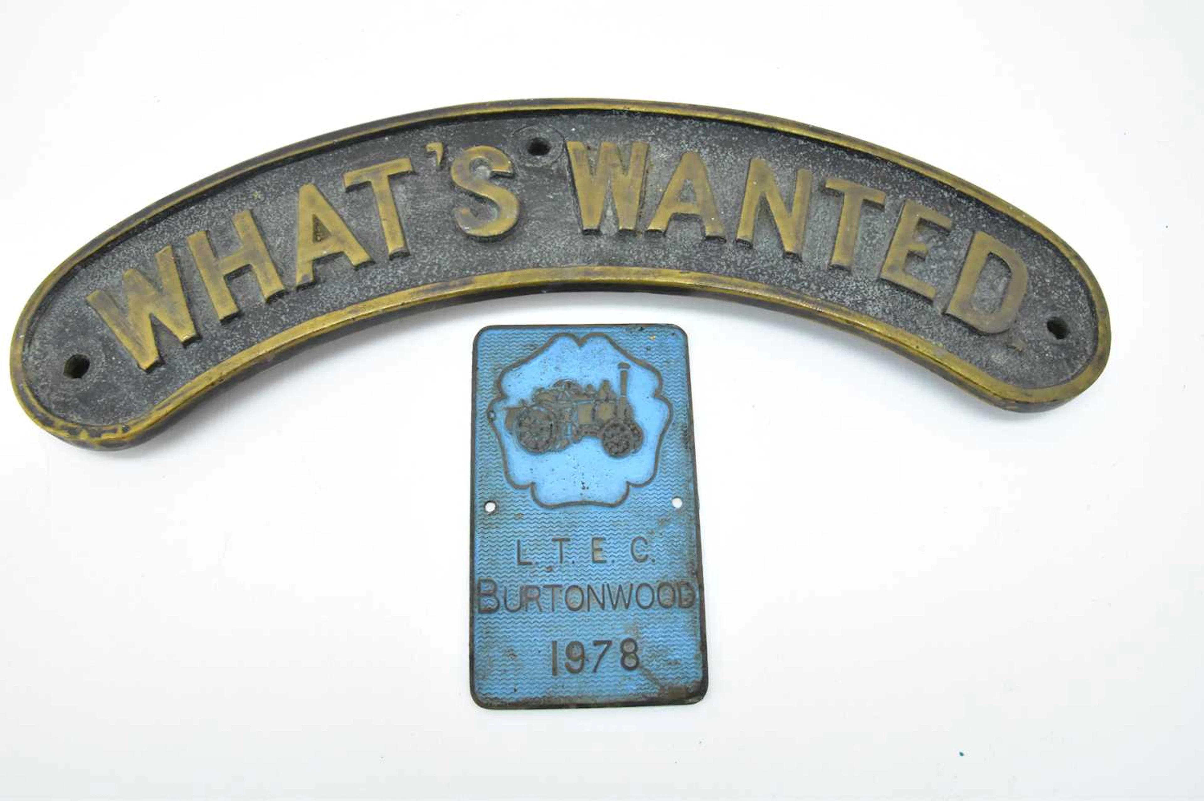 A steam engine brass name plaque titled 'What's Wanted'