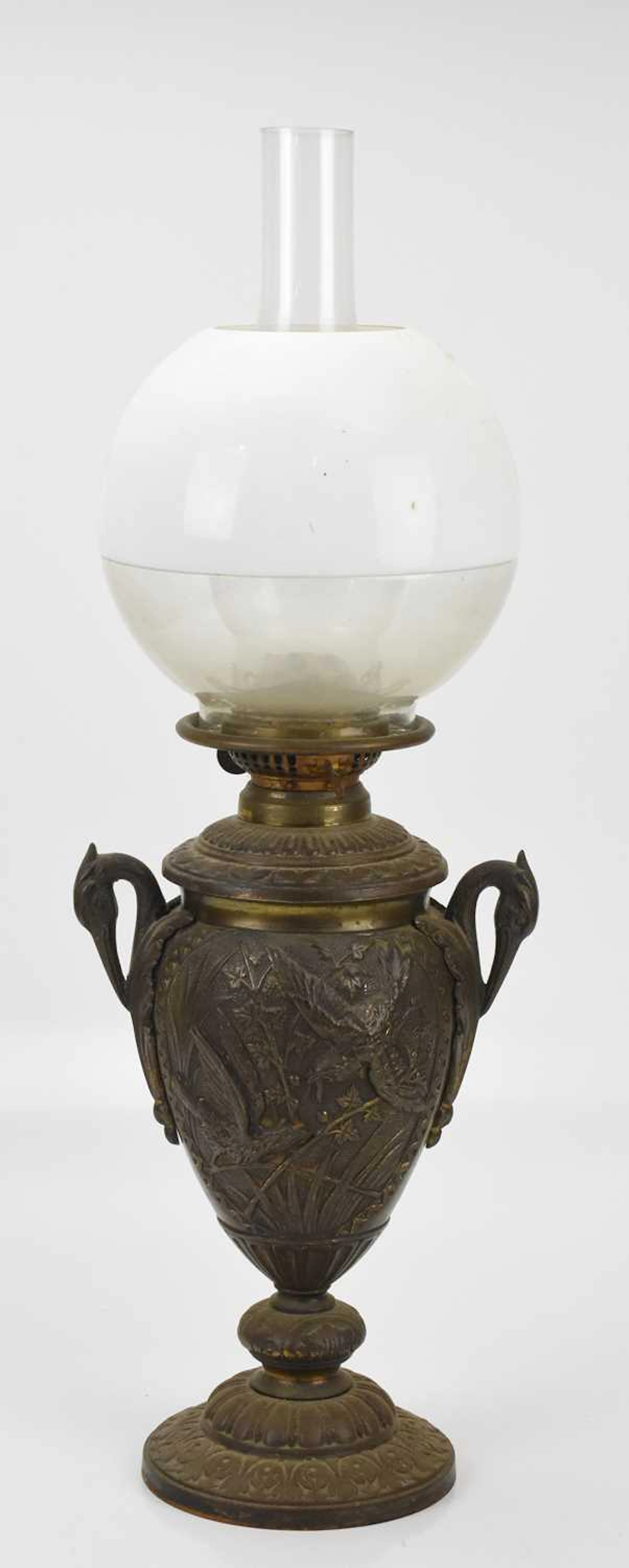 A late 19th century bronzed cast metal oil lamp