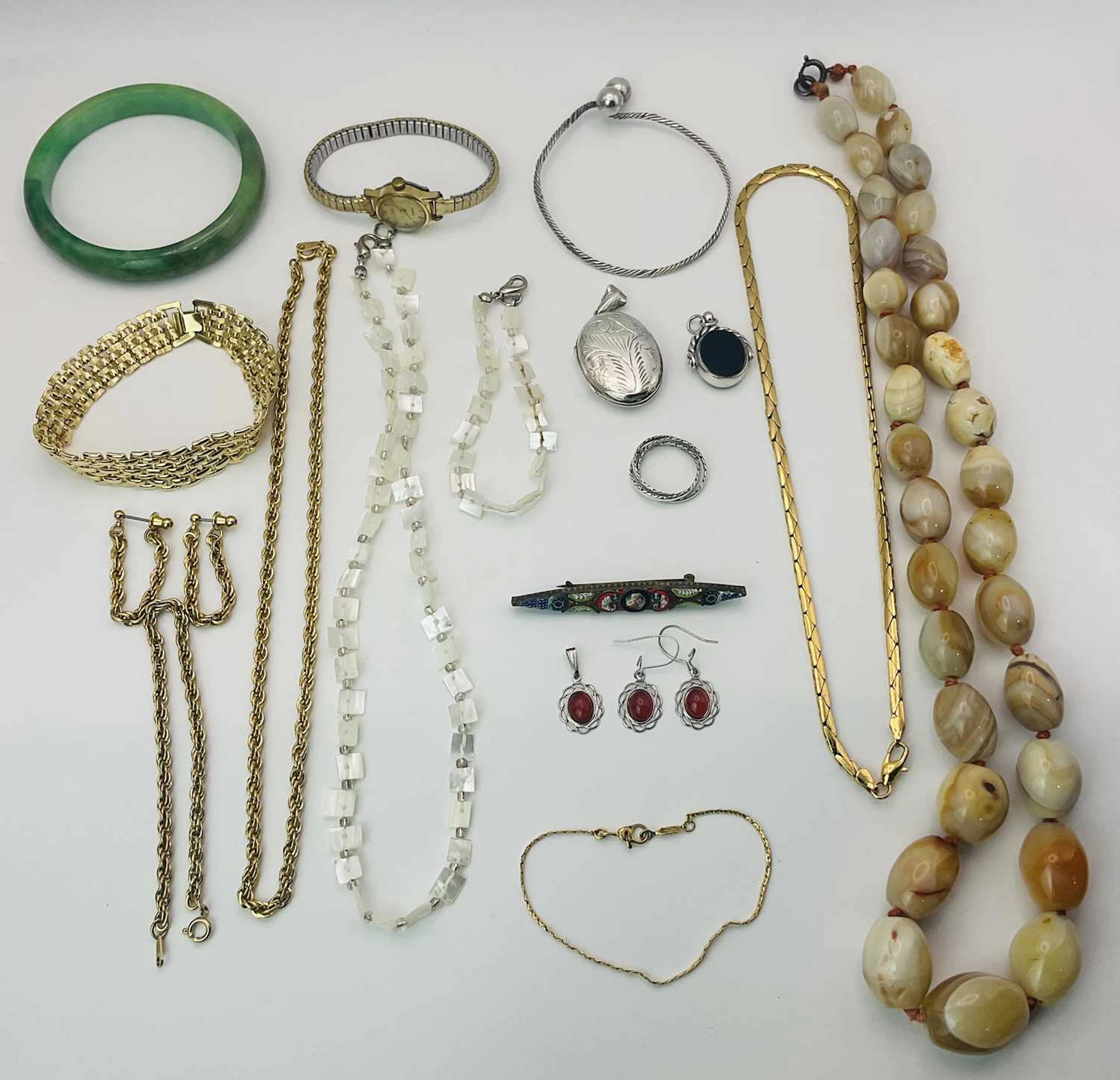 A quantity of costume jewellery to include a silver locket