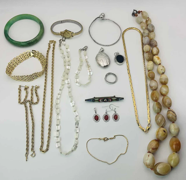 A quantity of costume jewellery to include a silver locket