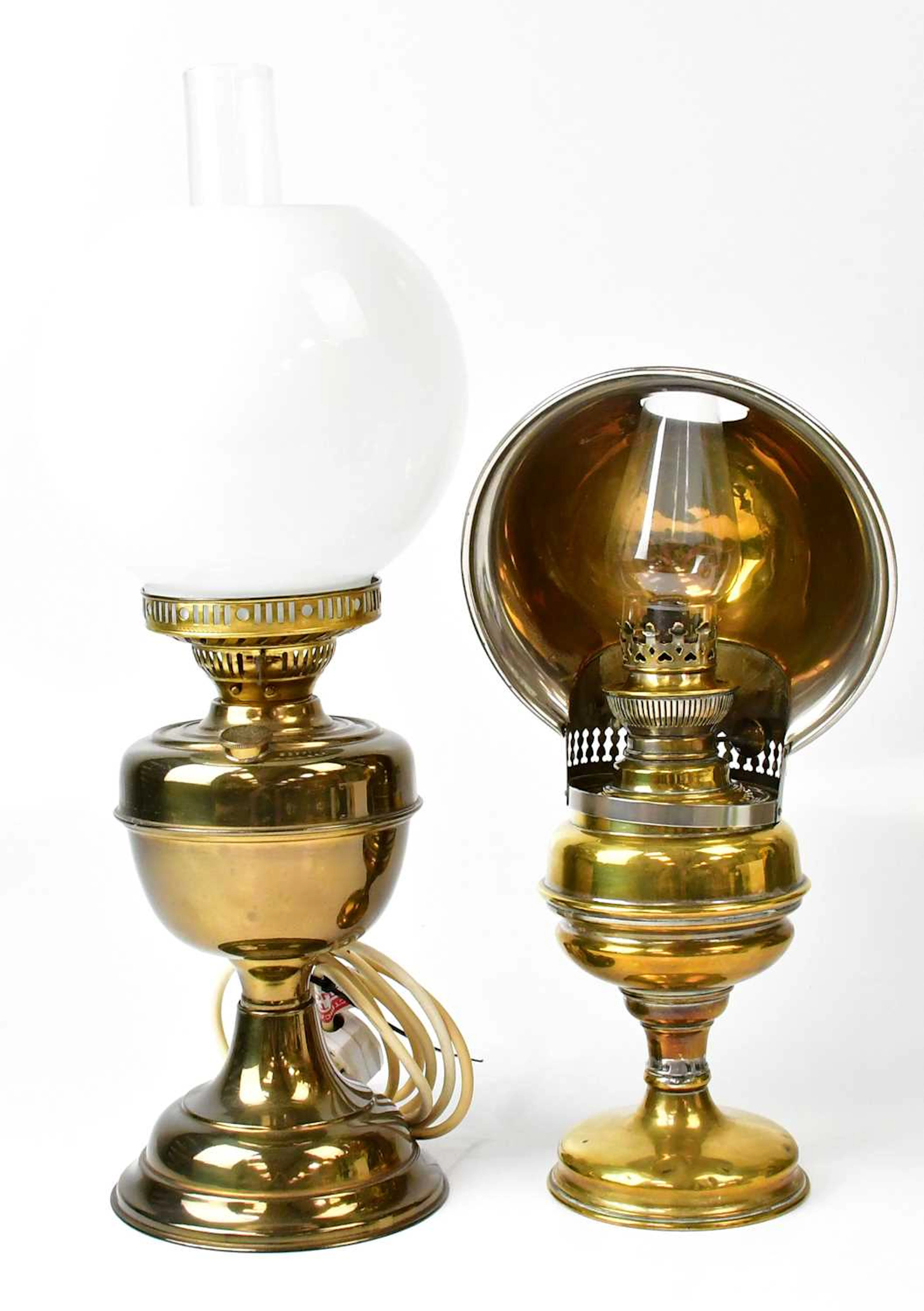 A vintage oil lamp with directional metal shade
