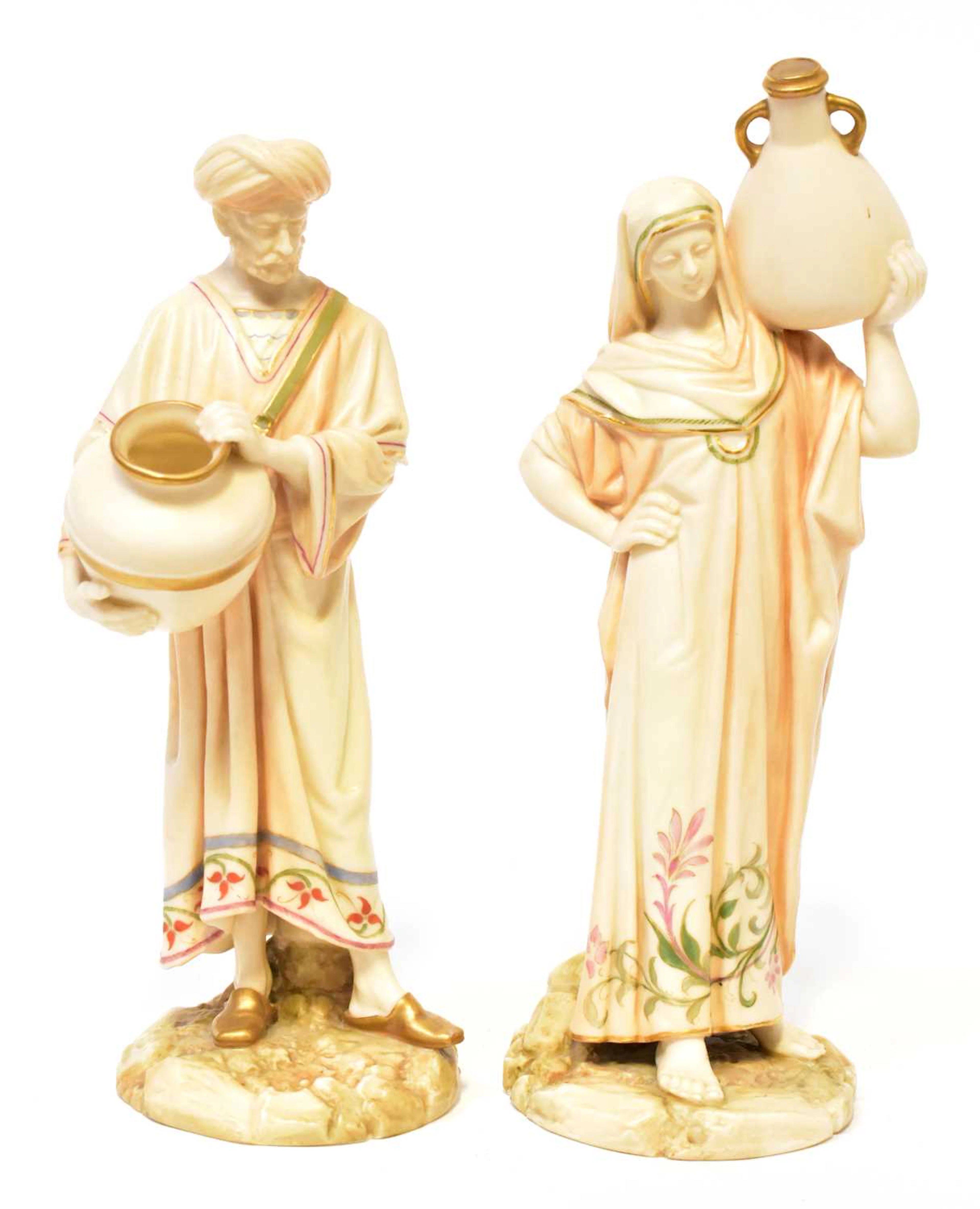 ROYAL WORCESTER; a pair of James Hadley porcelain figures of water carriers