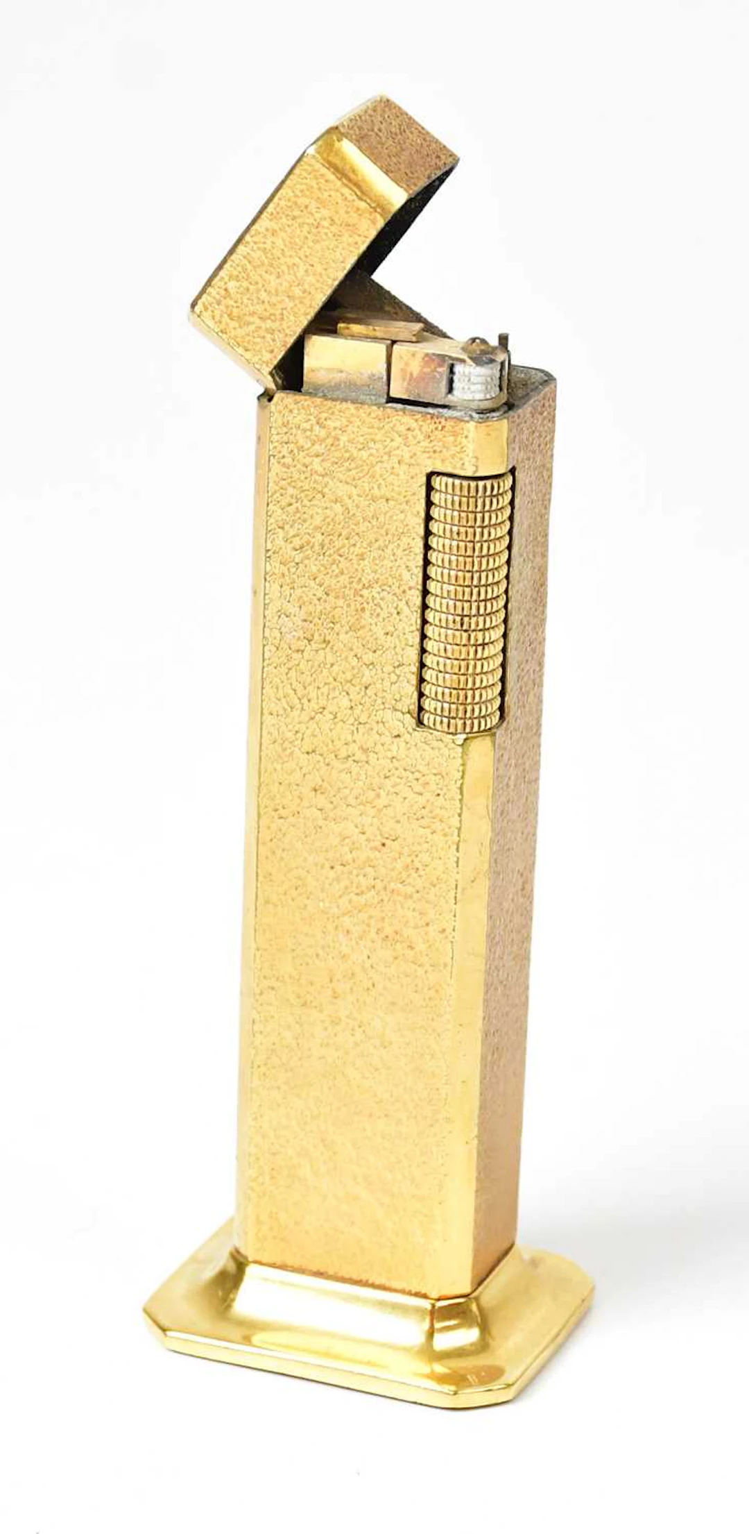 DUNHILL; a 1970s 'Tallboy' gold-plated table lighter with textured decoration