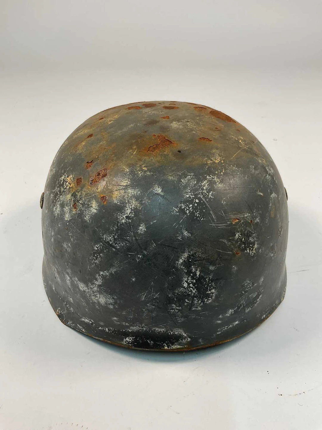 A WWII German Fallschirmjager helmet,with indistinct...