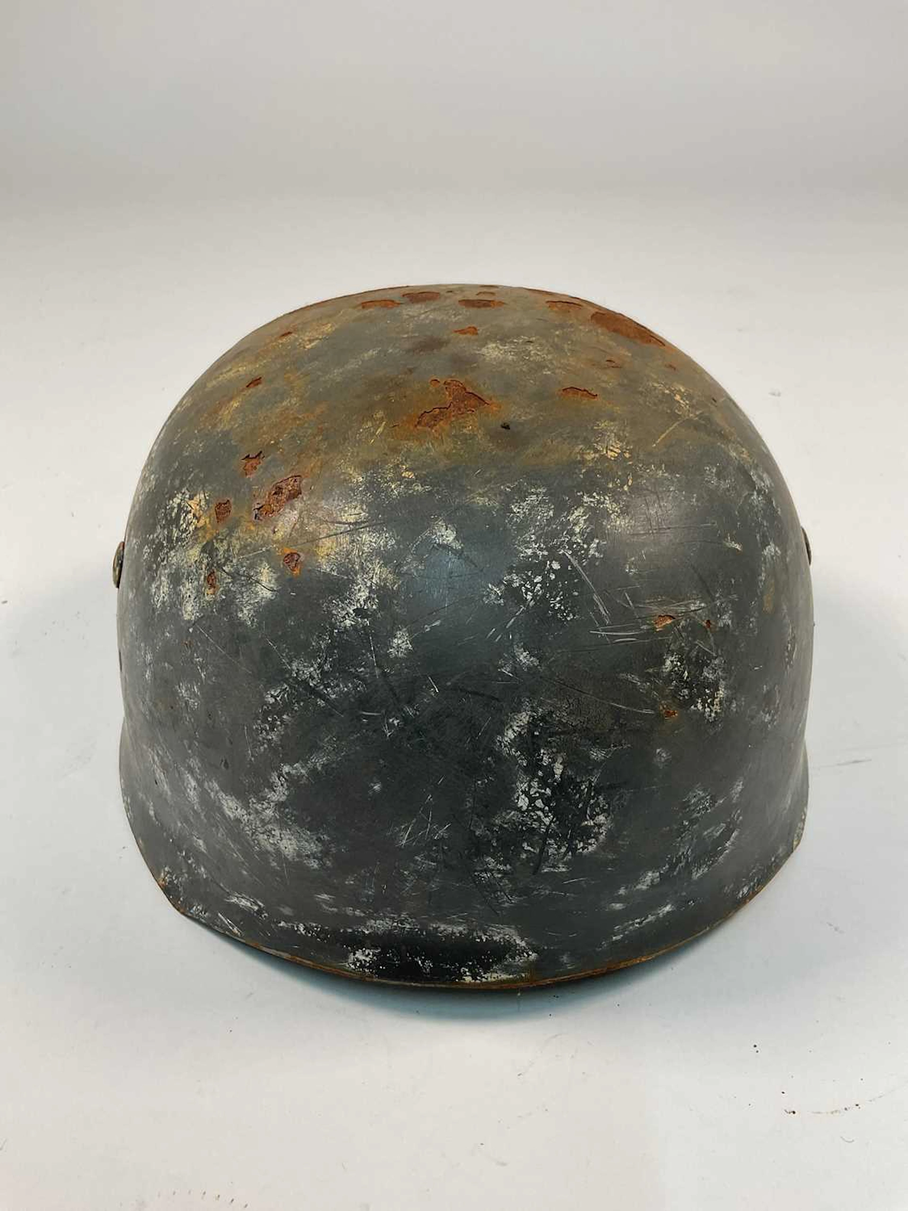 A WWII German Fallschirmjager helmet,with indistinct...