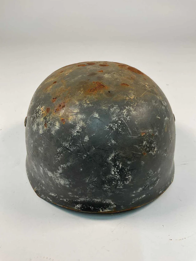 A WWII German Fallschirmjager helmet,with indistinct...