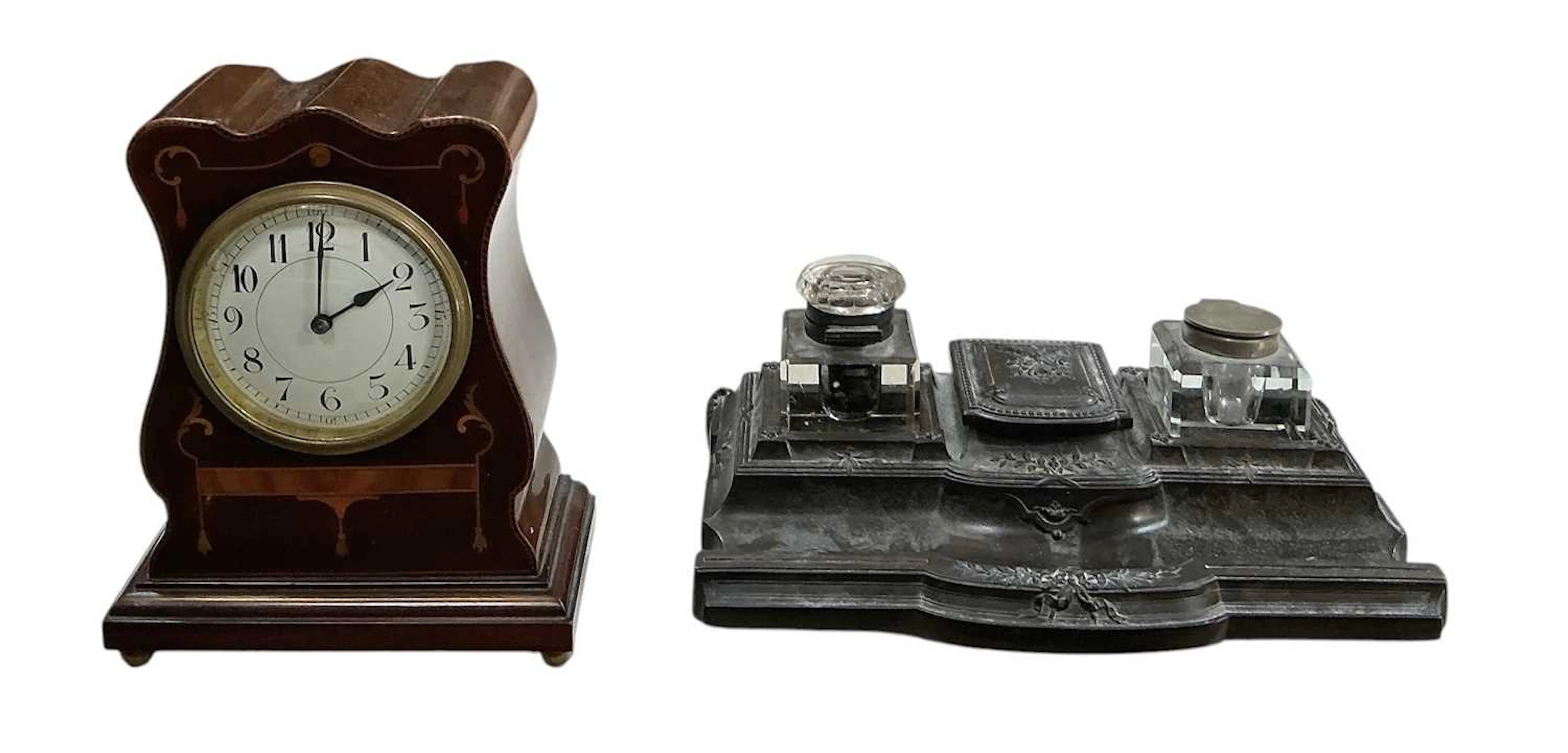 An early 20th century bakelite brass inlaid inkwell stand