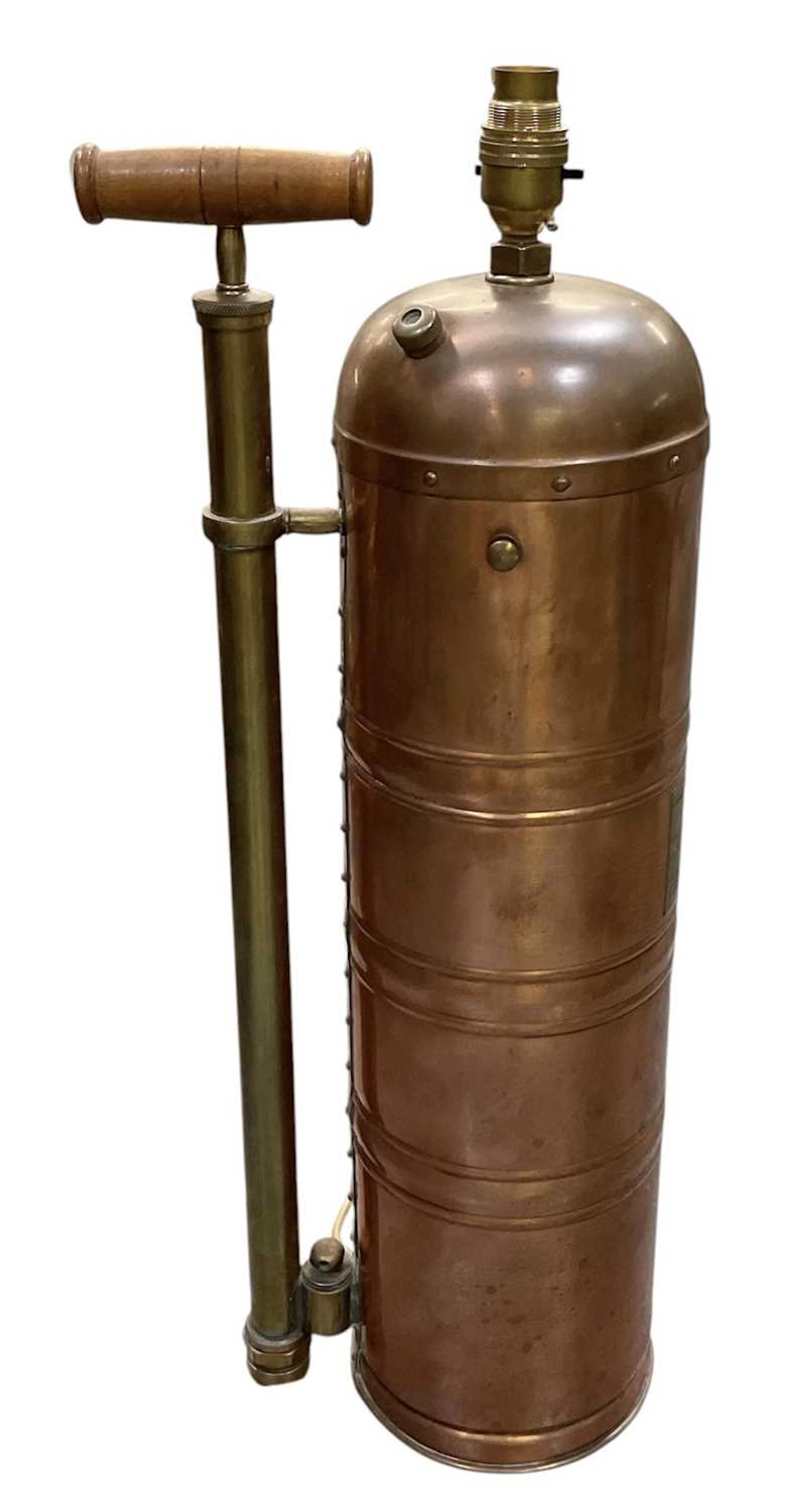 A vintage copper and brass fire extinguisher
