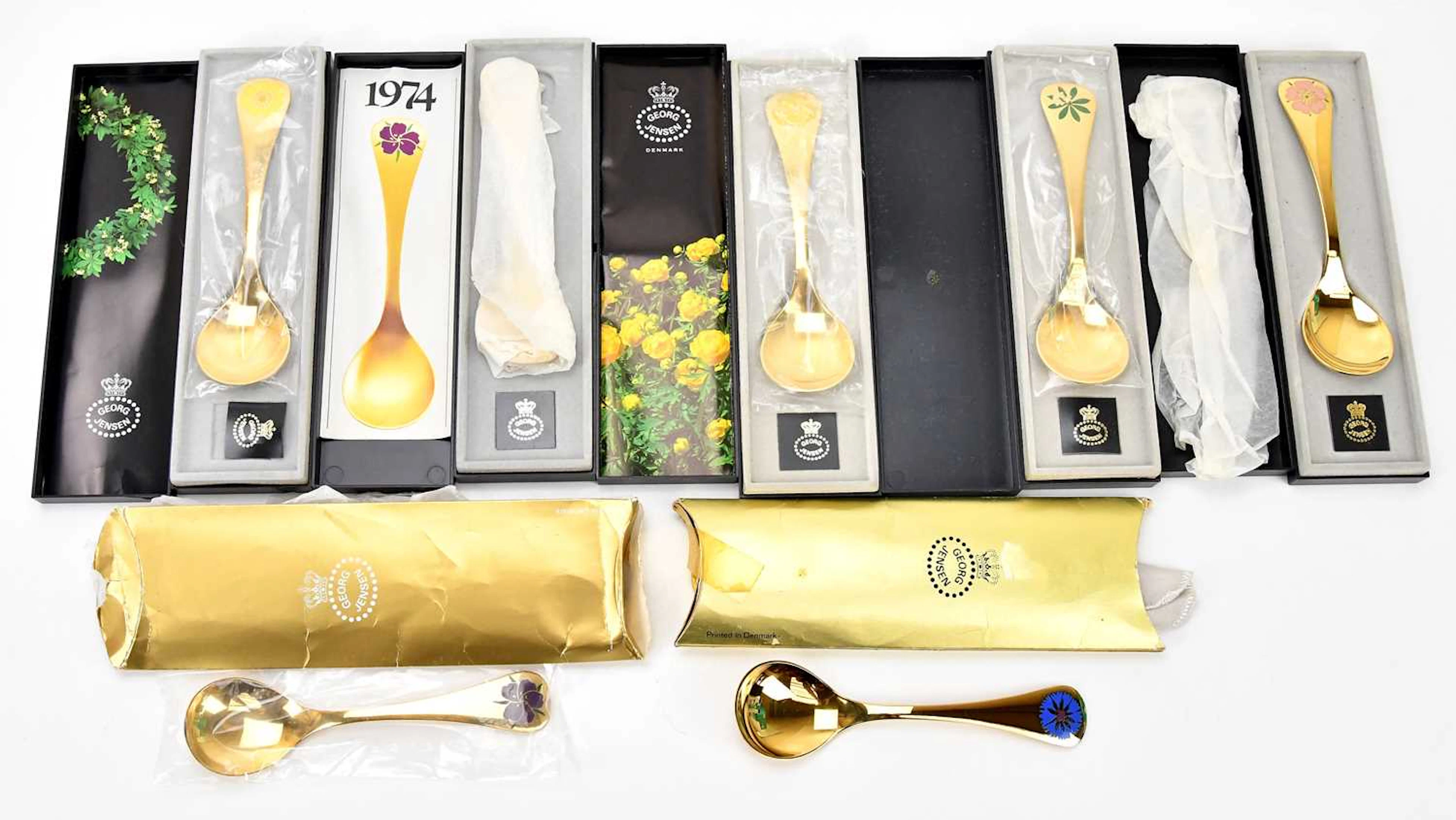 GEORG JENSEN; seven silver gilt and enamel year spoons