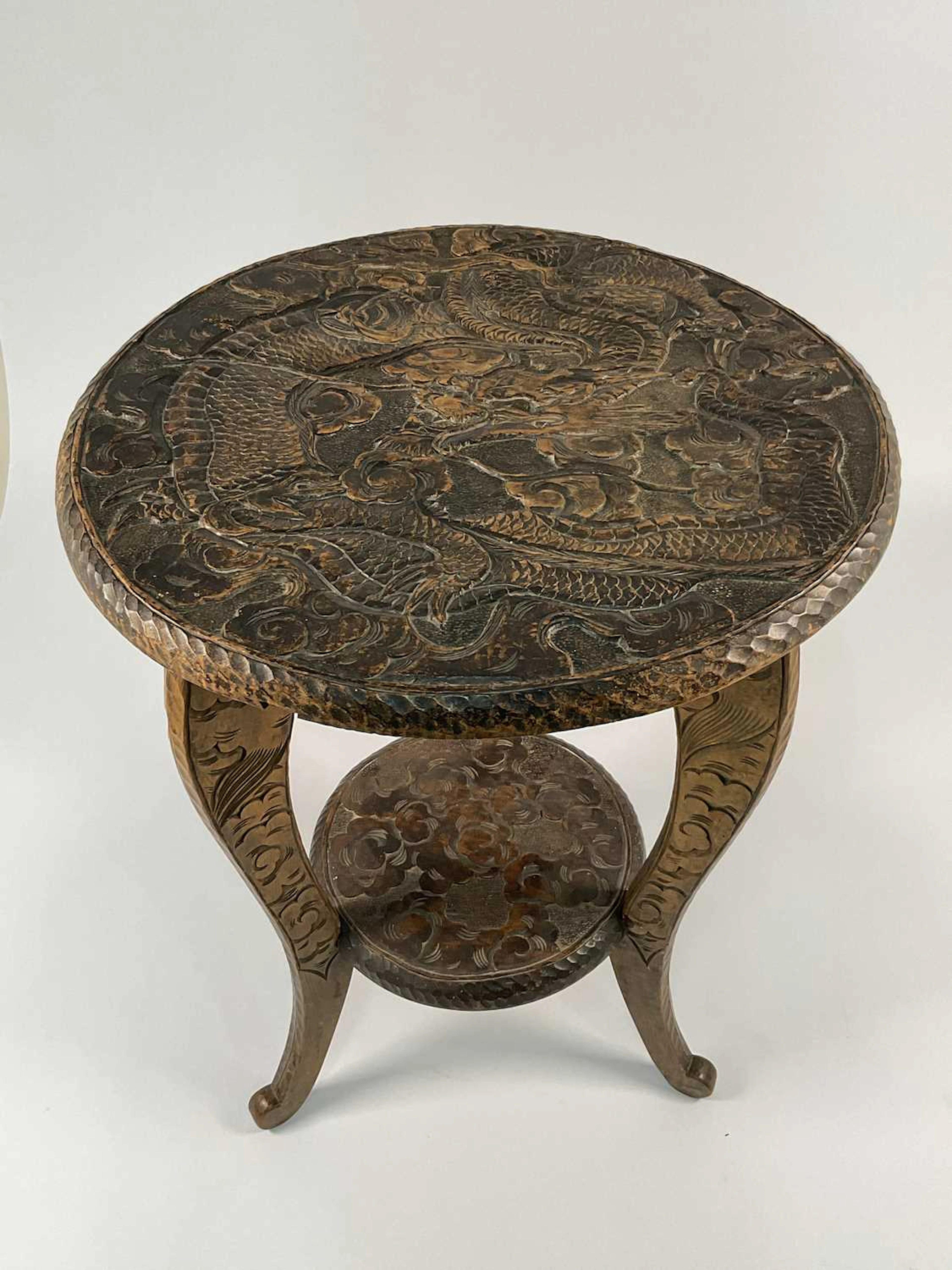An Edwardian two tier Japanese carved tripod table