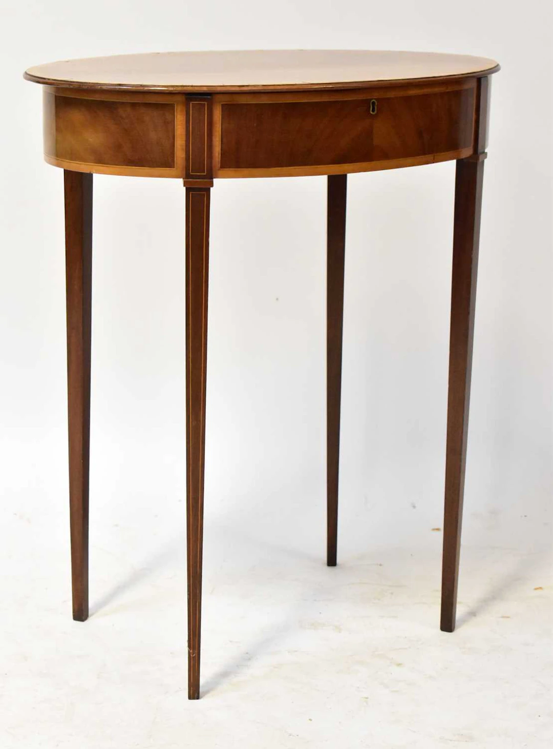 An Edwardian Sheraton style mahogany work table