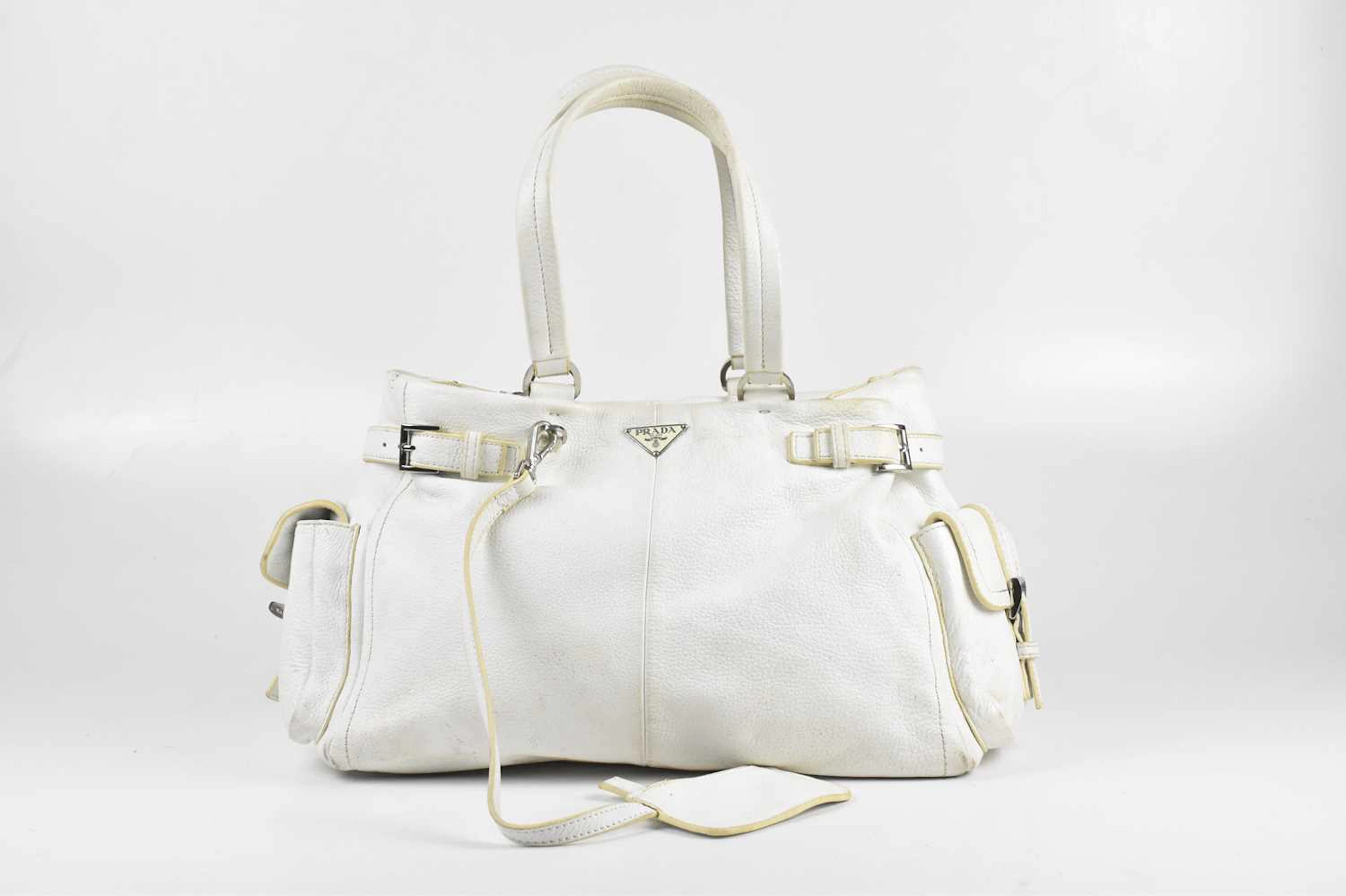 PRADA; a white grained calfskin leather handbag with chrome hardware