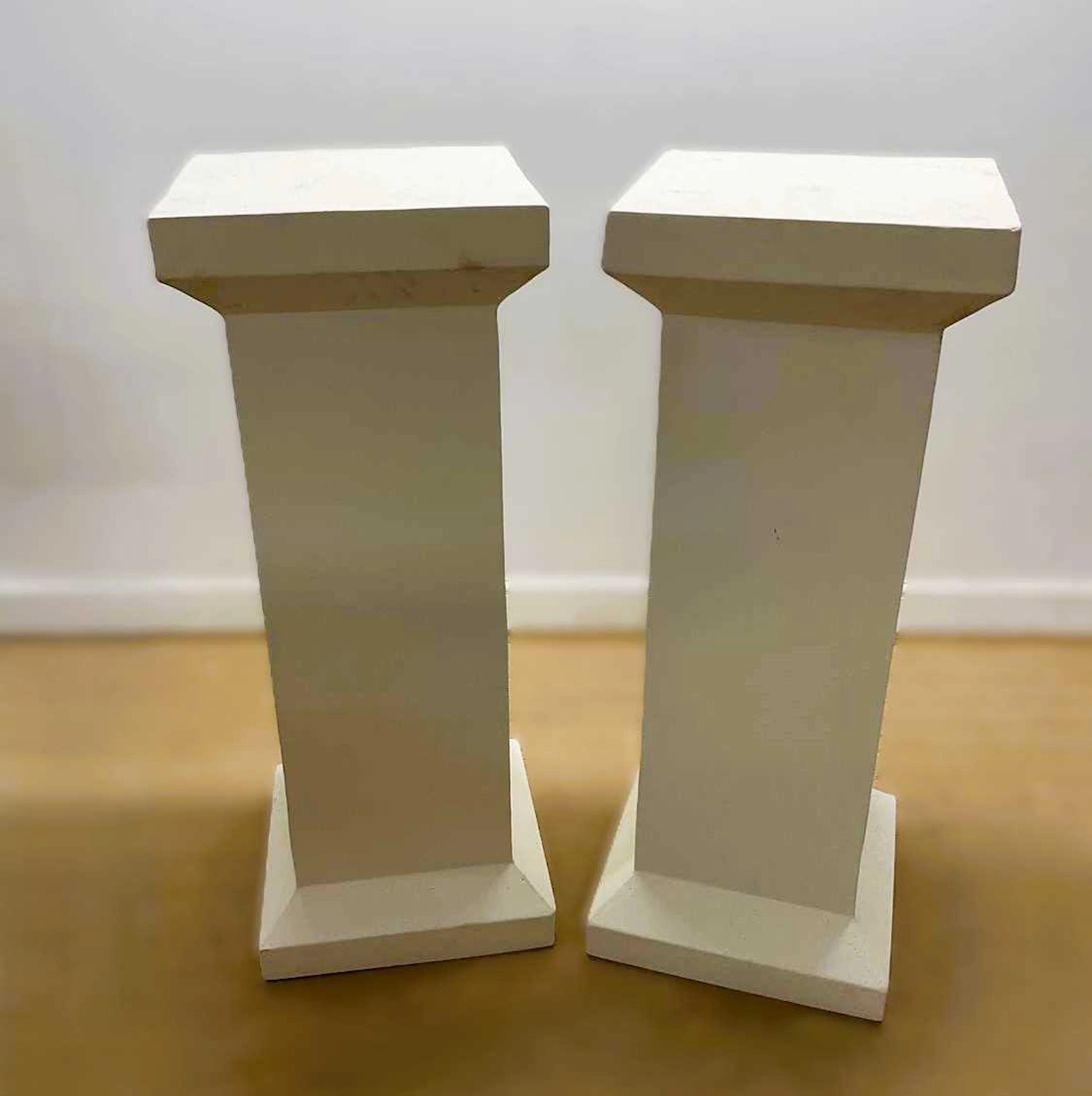 A pair of painted zinc pedestals