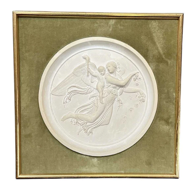 An early 20th century circular plaster relief wall...