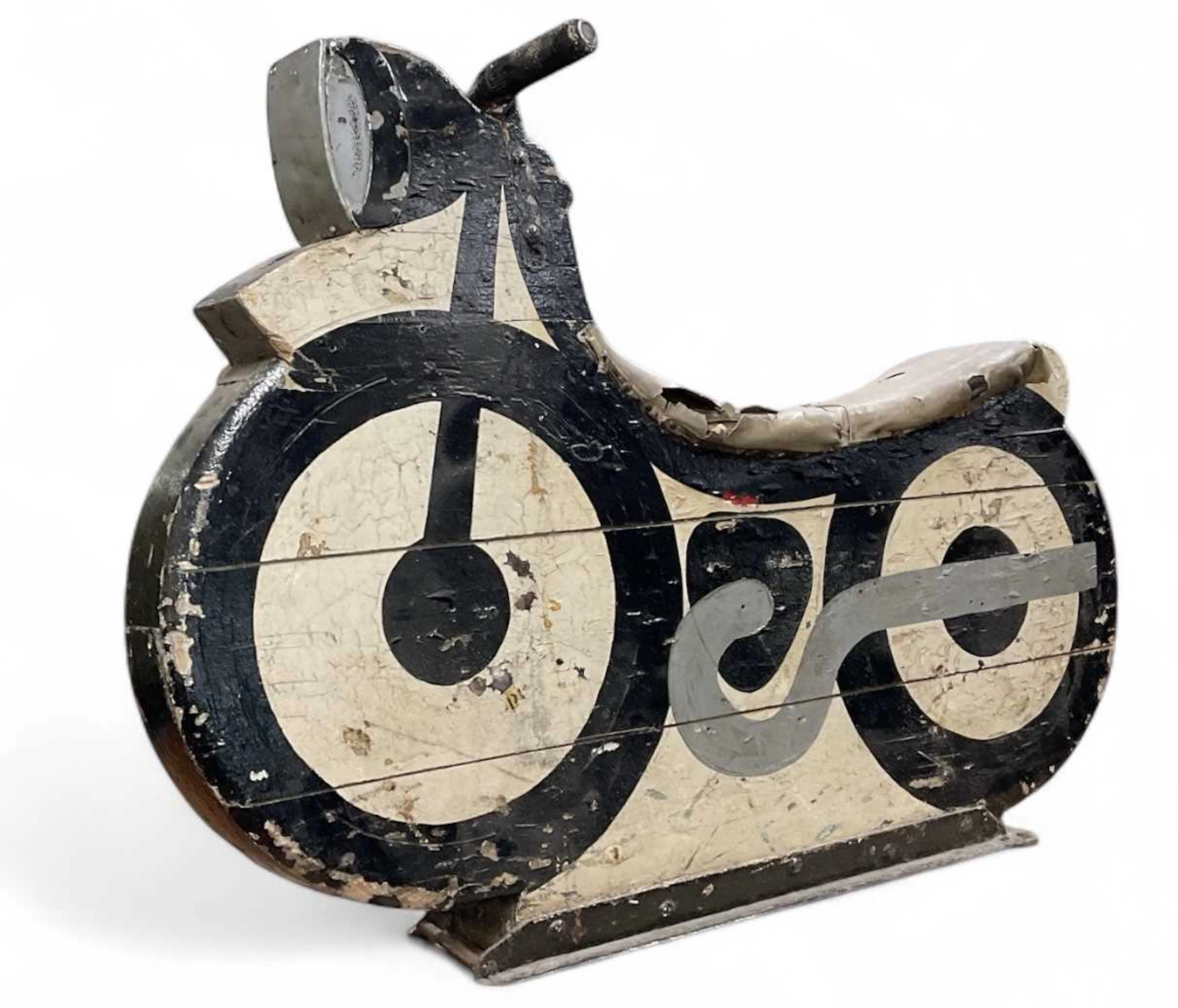 A vintage carved wooden black and white painted speedway...
