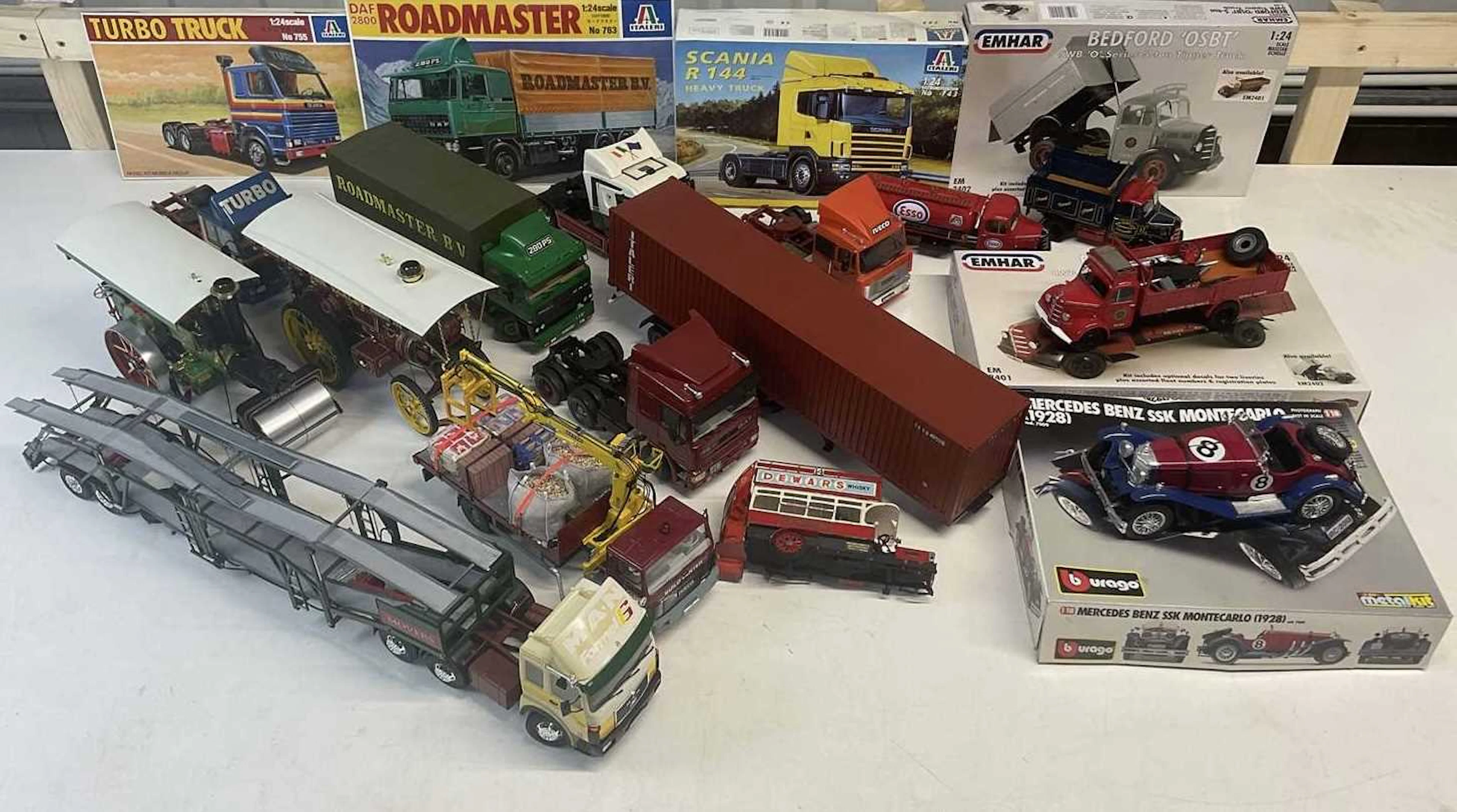 A collection of plastic and metal model vehicle kits