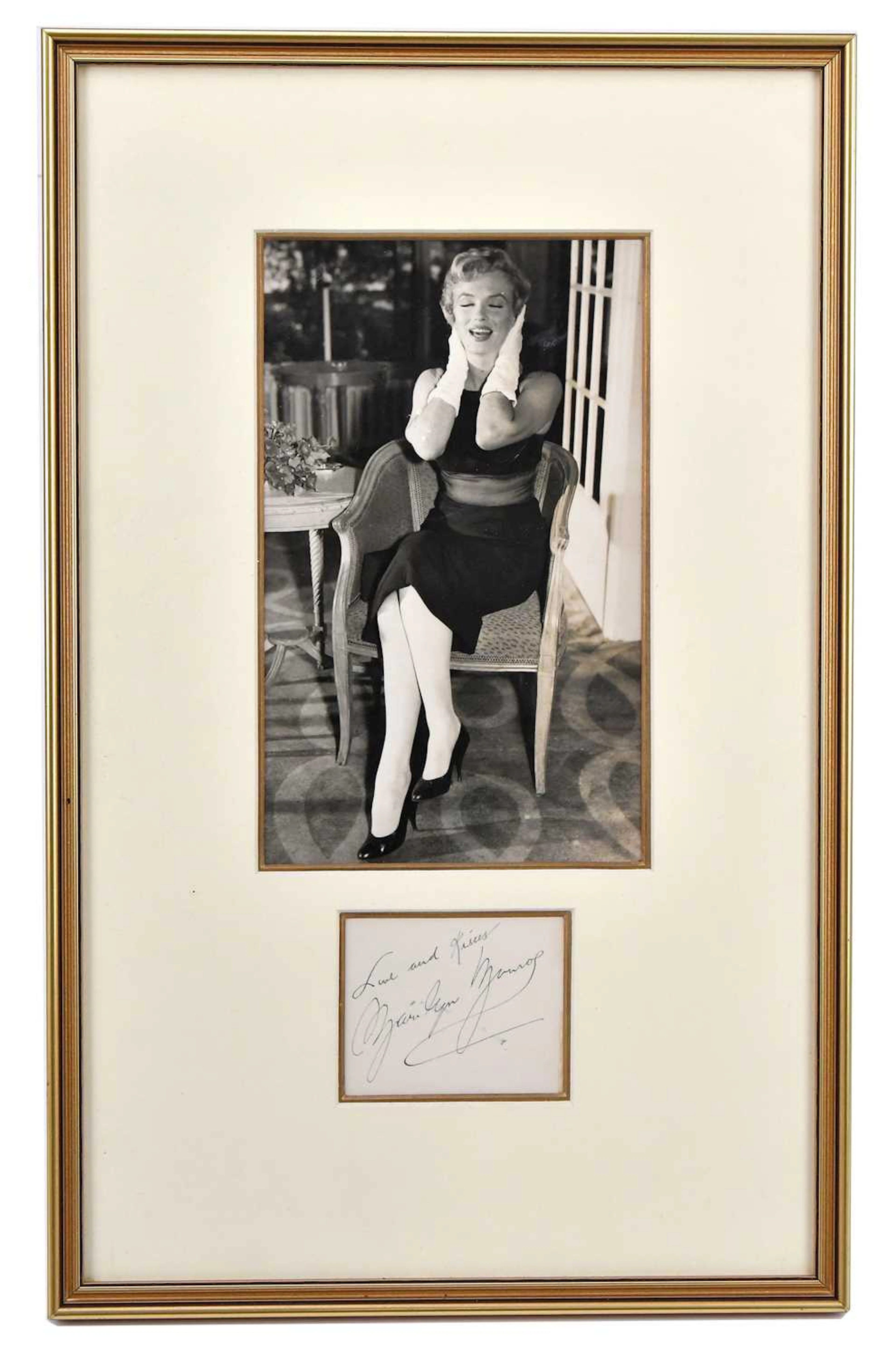 MARILYN MONROE; a black and white photograph with a signed note ‘Love and Kisses