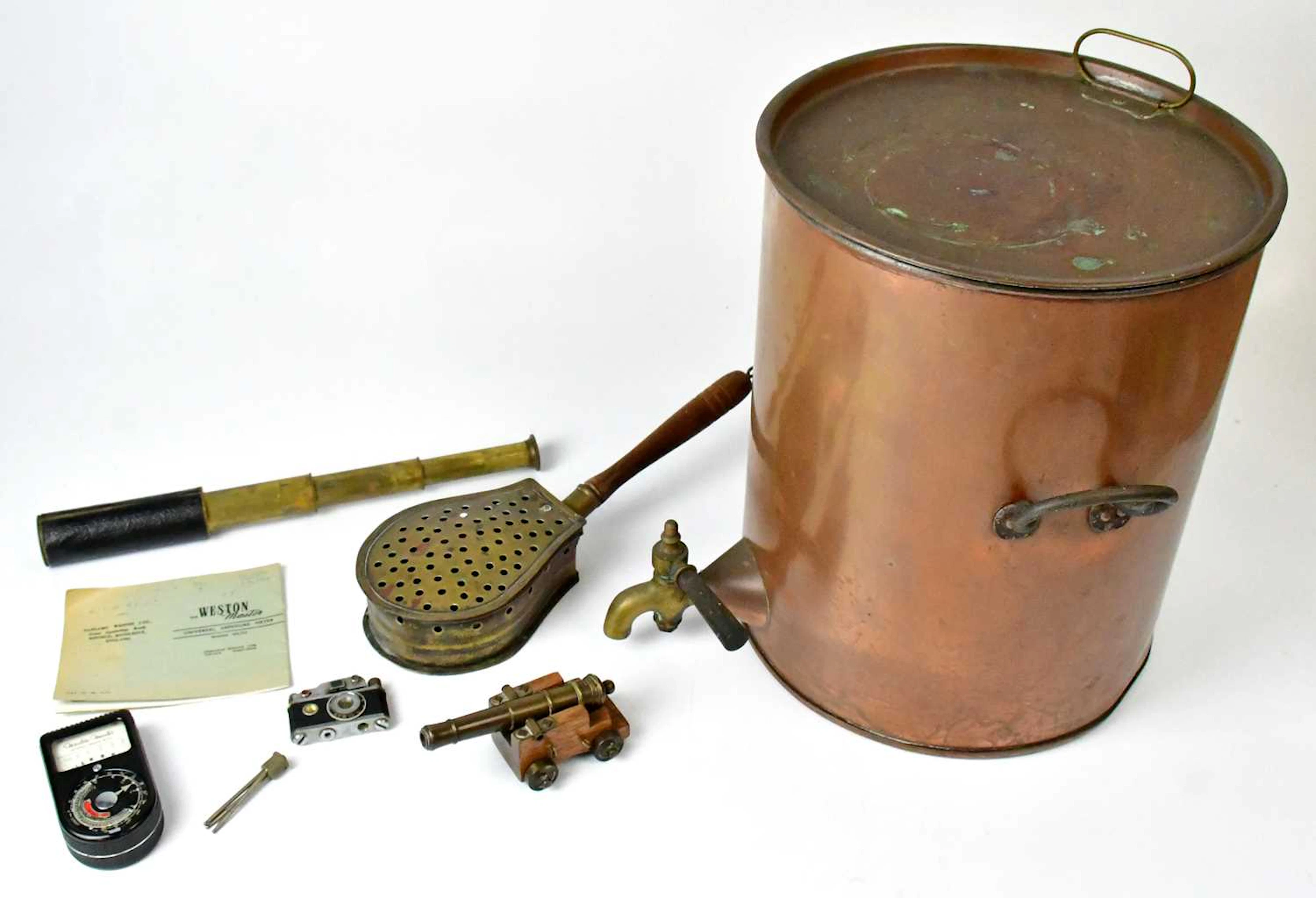 A copper tea urn of cylindrical form with lift up lid and twin handles