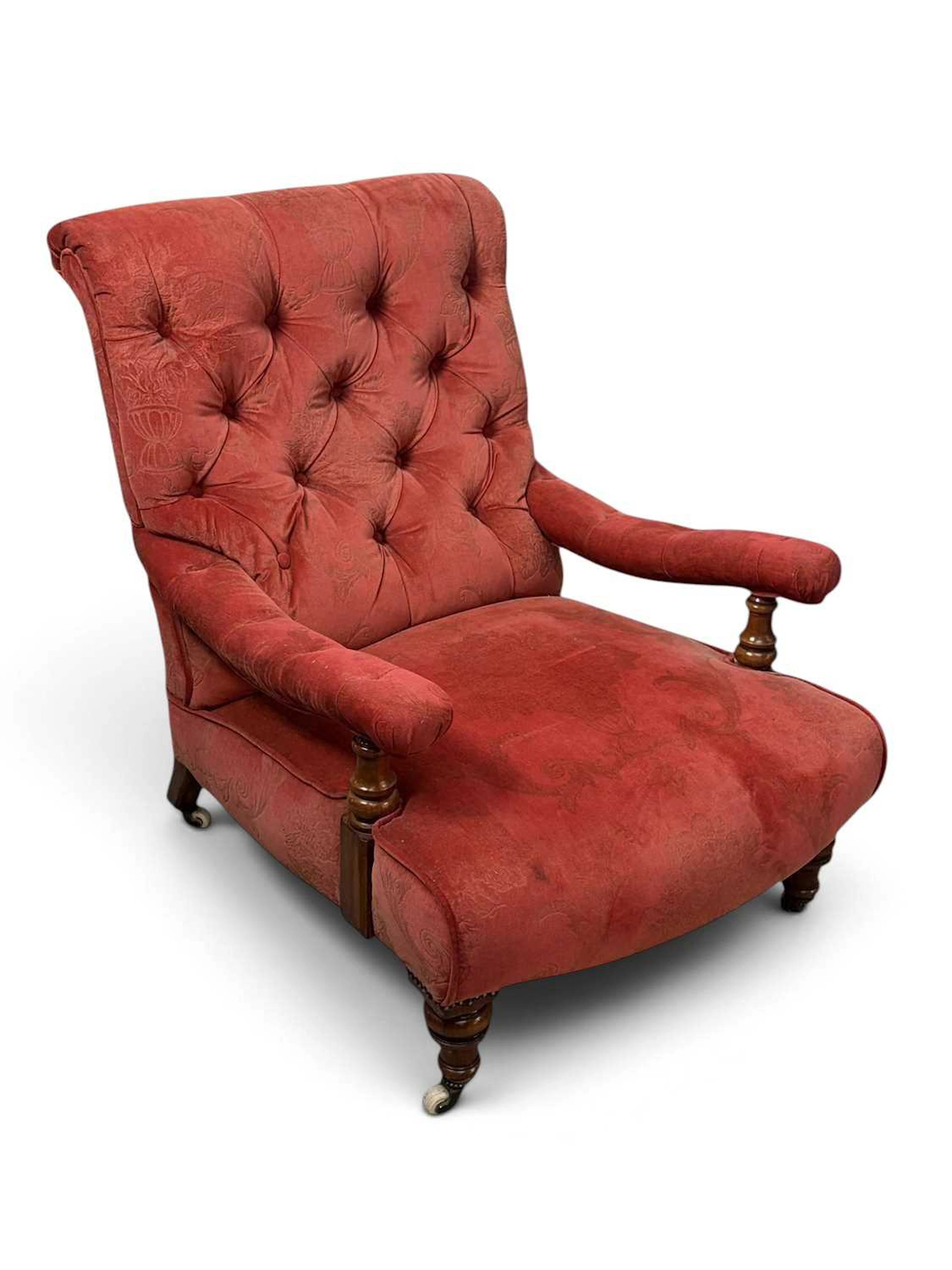 A Victorian walnut library chair in the manner of Howard & Sons