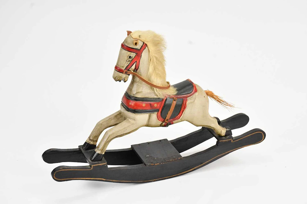 A hand carved black and white painted model rocking horse