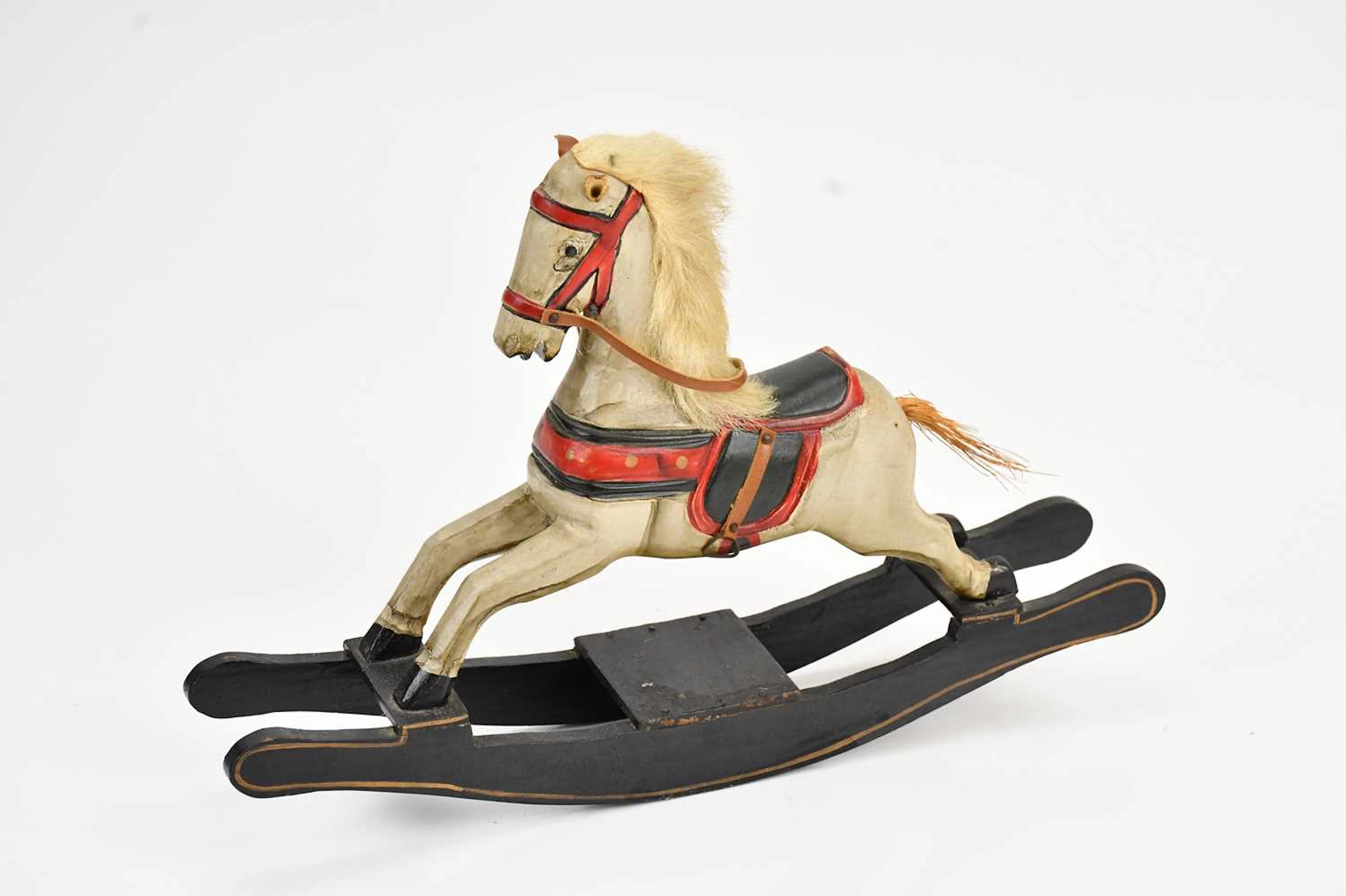 A hand carved black and white painted model rocking horse