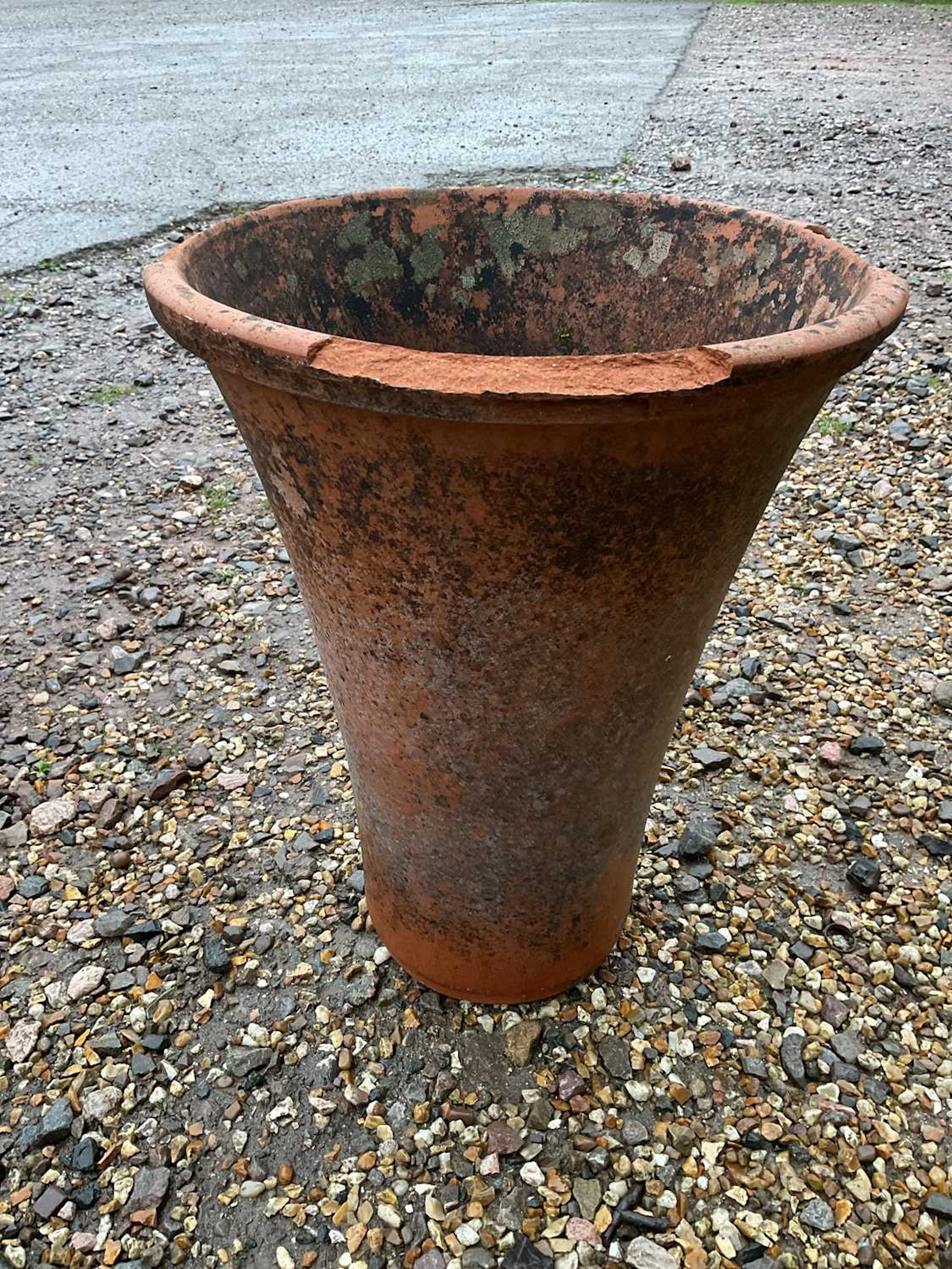 A large terracotta pot/planter of tapering form