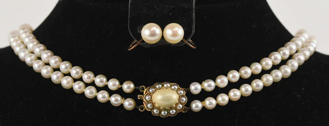 K MIKIMOTO; a cased early 20th century two strand cultured pearl bead necklace