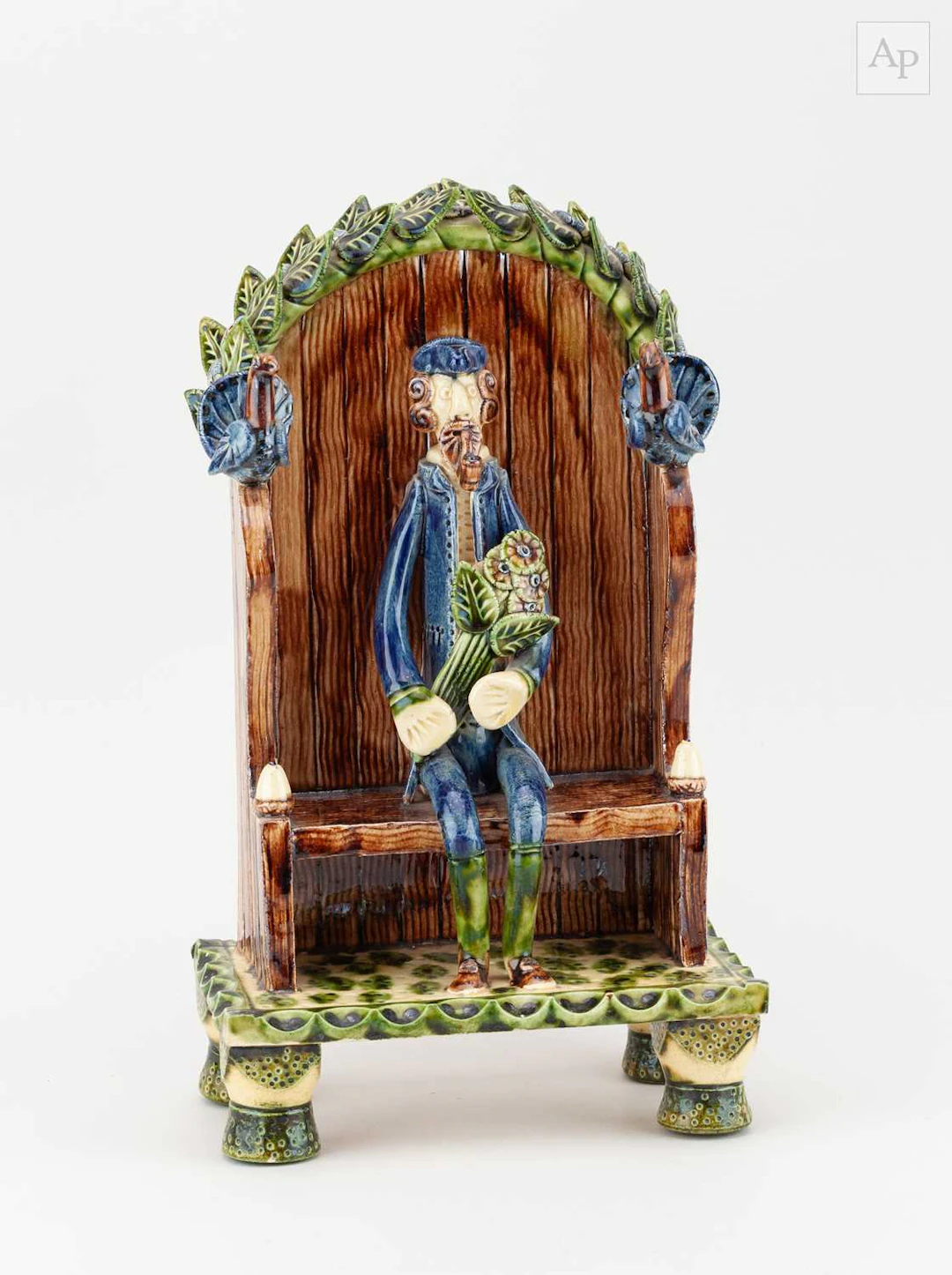PAUL YOUNG (born 1961); a slipware sculpture of a man on a bench