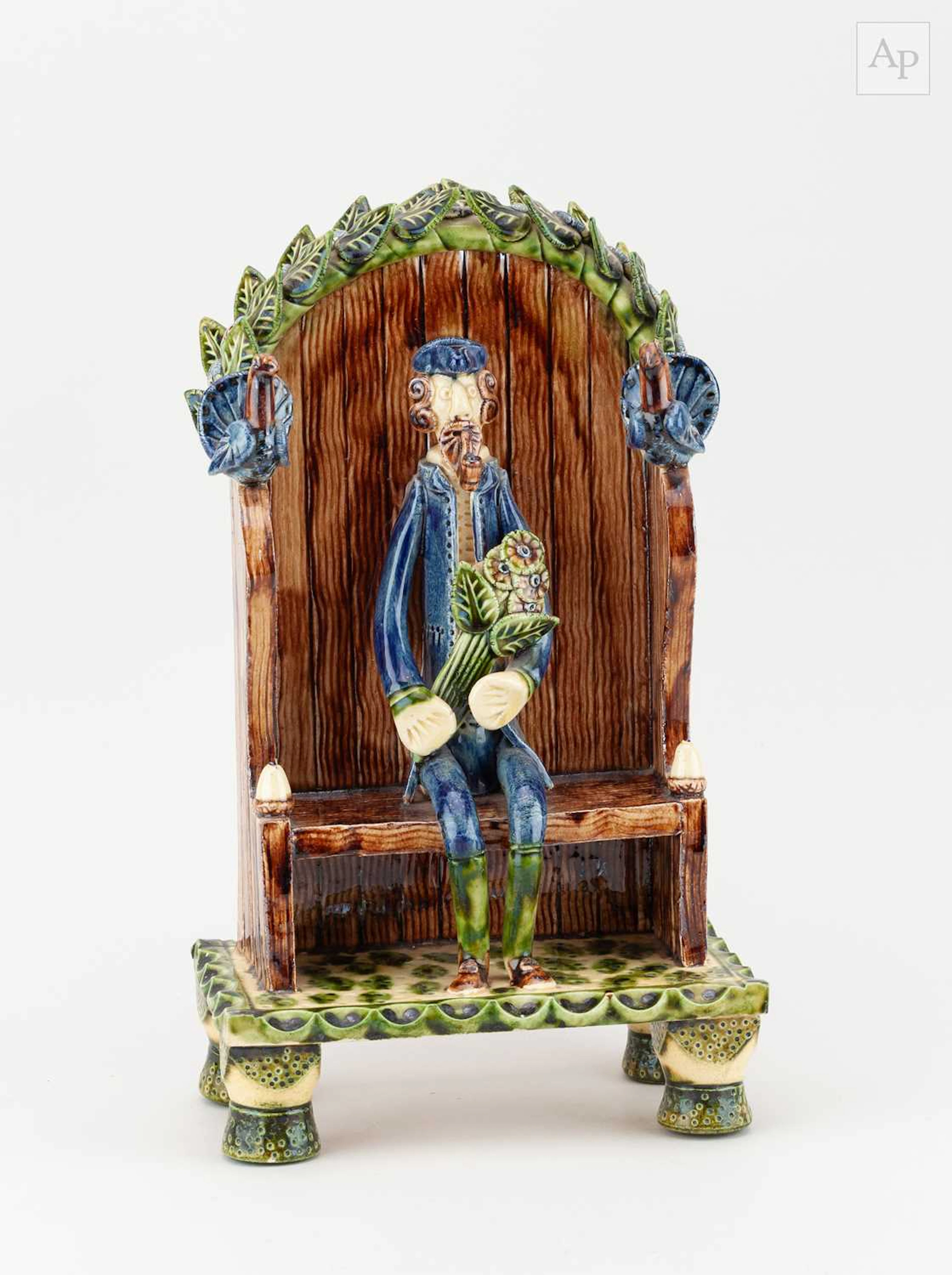 PAUL YOUNG (born 1961); a slipware sculpture of a man on a bench