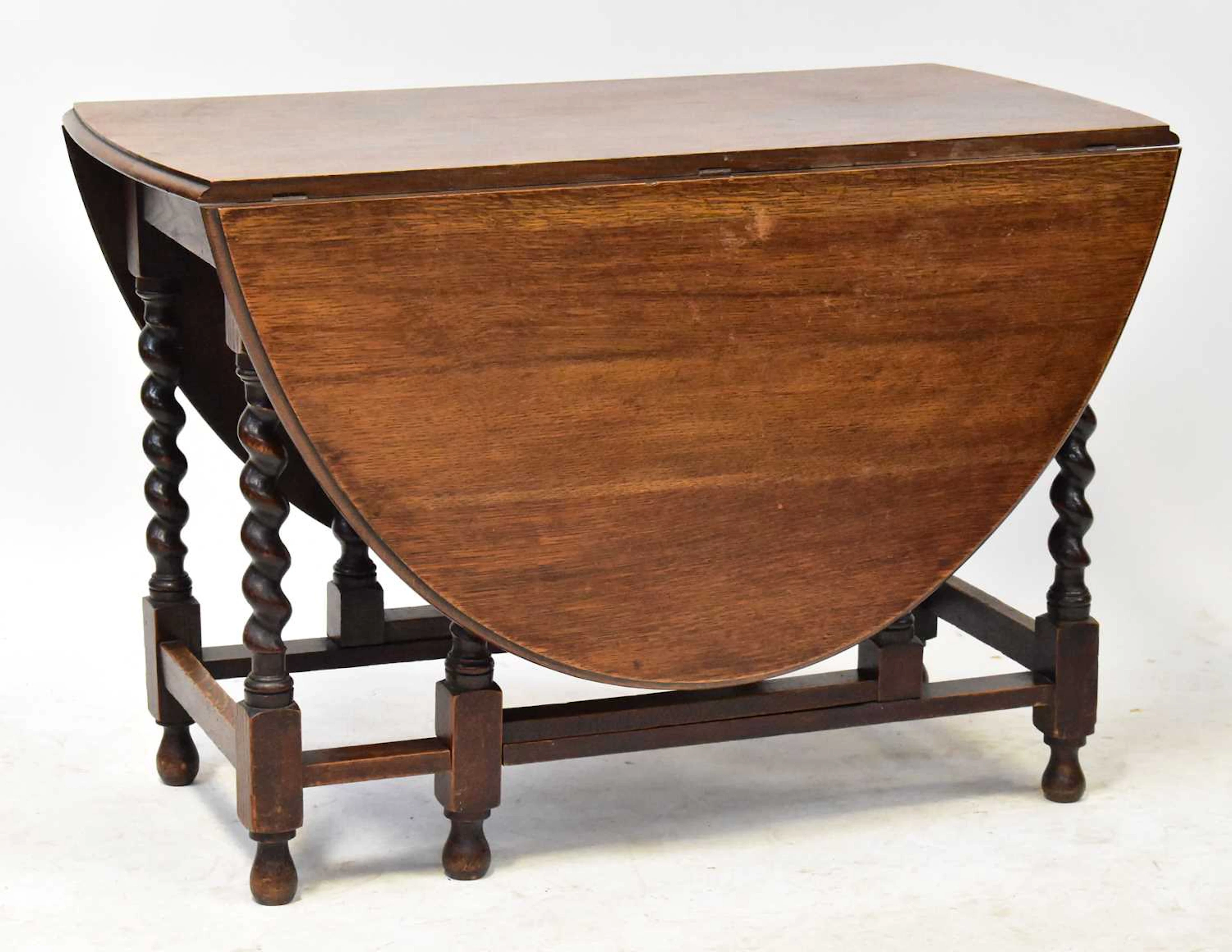 A 1930s oak drop-leaf gateleg supper table