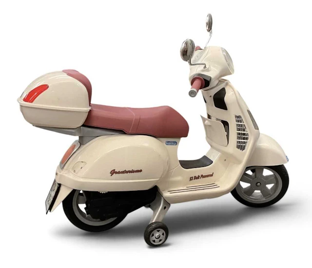 A child's 12 volt powered ride-on Vespa scooter by Peg-Perego