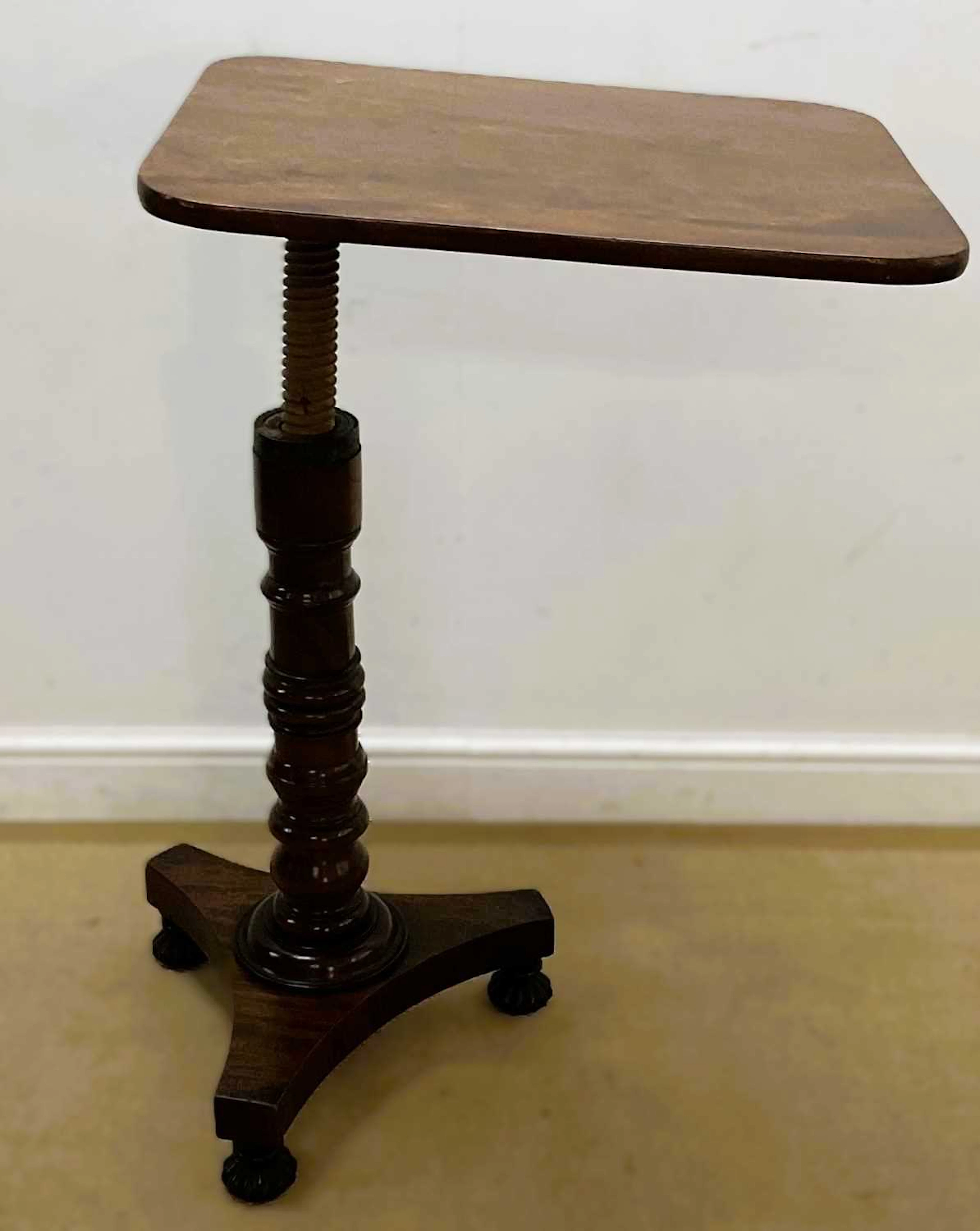 A Victorian adjustable bed/reading table raised on central column