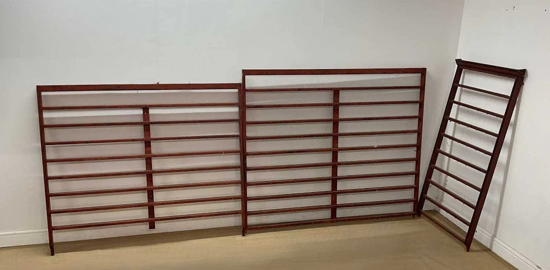 Three painted wall hanging displays each with numerous hooks for cups