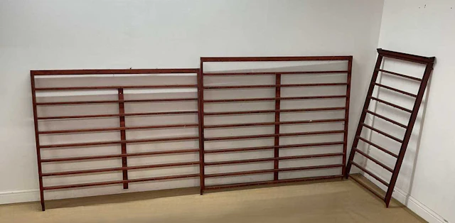 Three painted wall hanging displays each with numerous hooks for cups