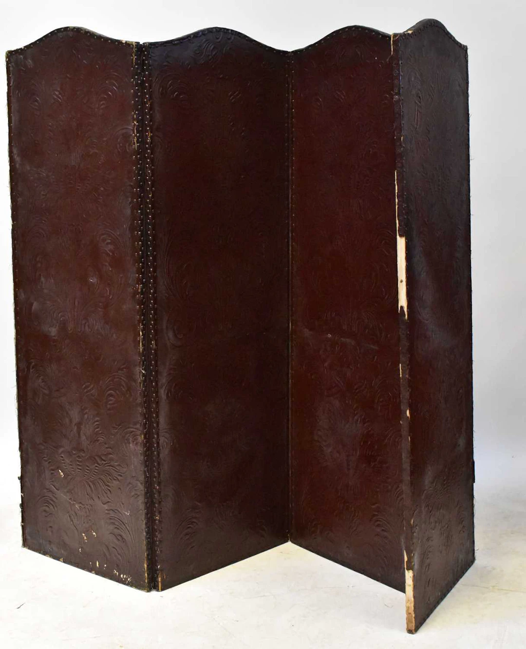 A late Victorian embossed leather four-fold screen