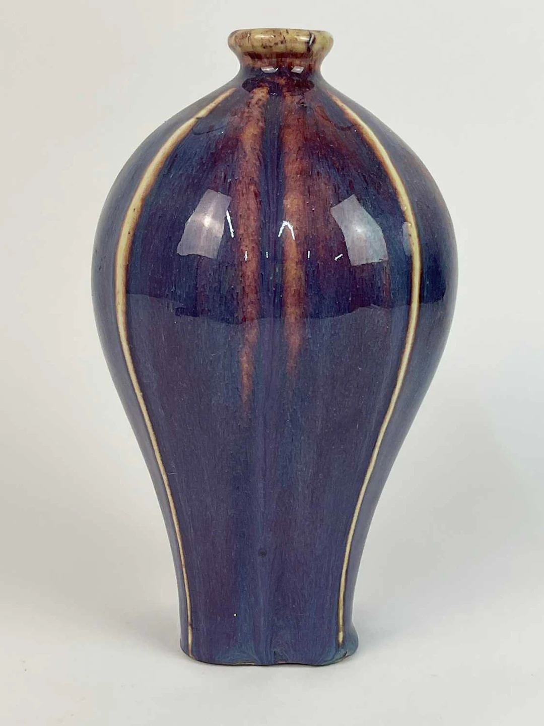 A Chinese flambé glazed vase with vertical ridges