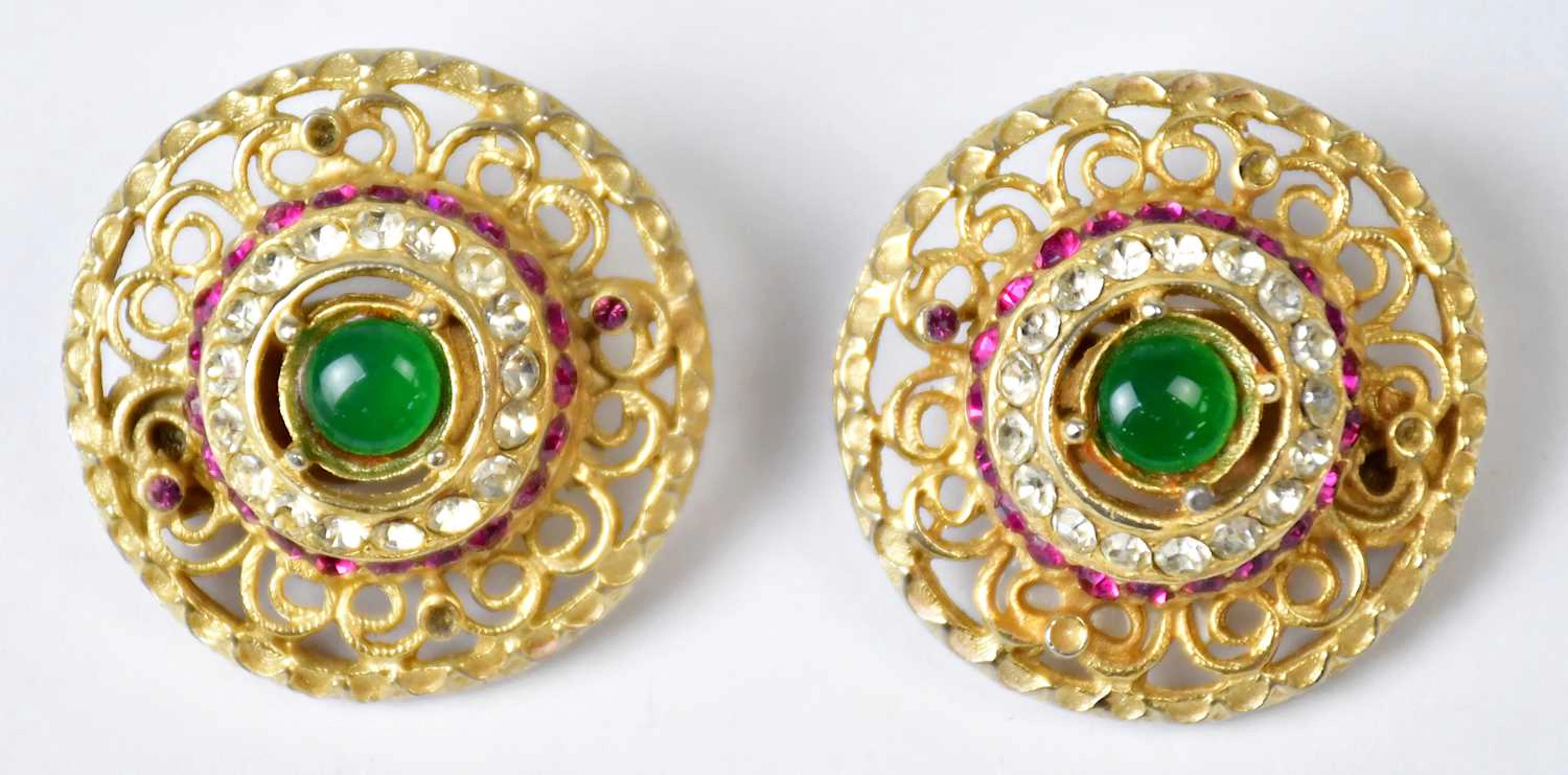HEIDI DAUS FOR JIM WALTERS; a pair of gold-coloured circular clip-on earrings