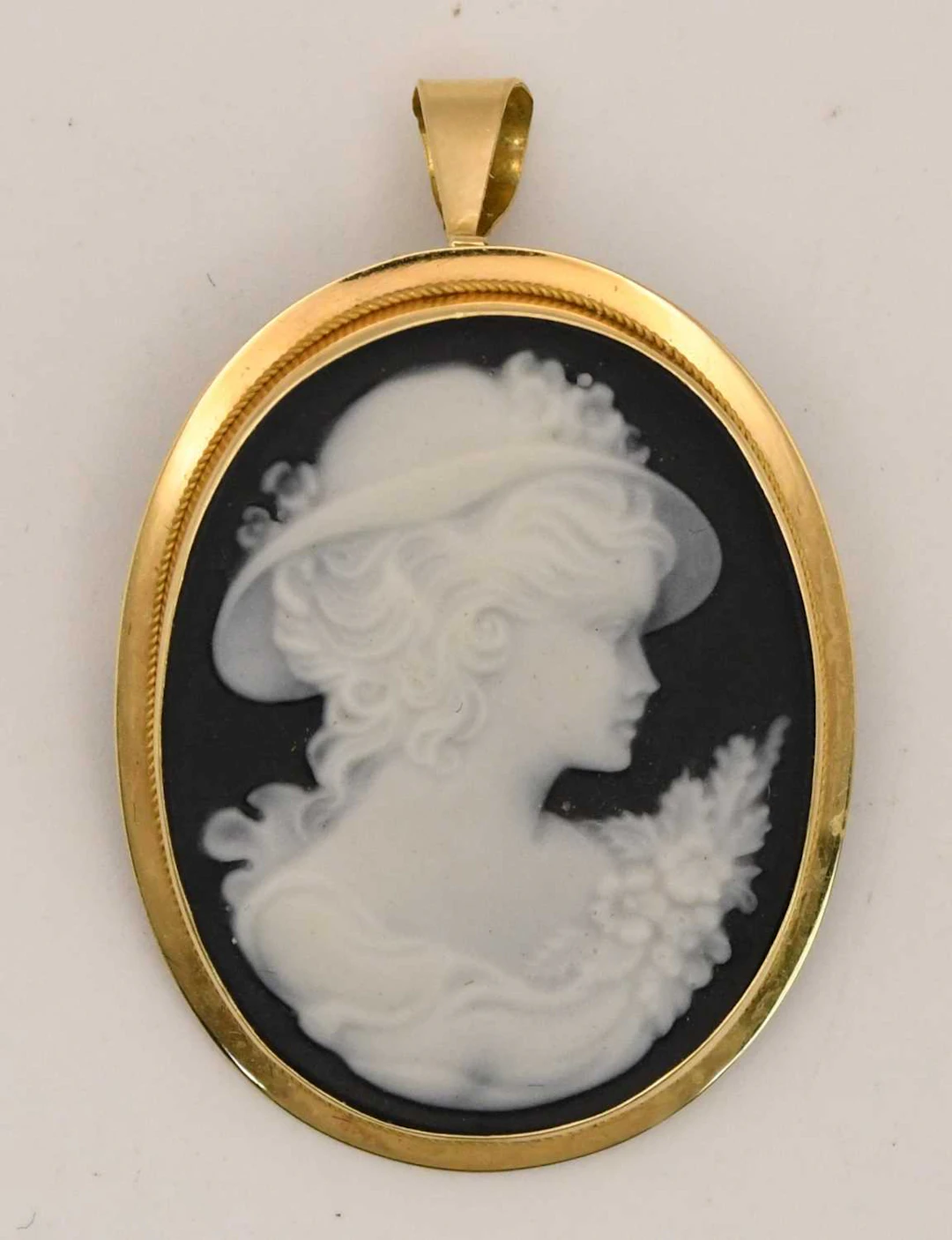 A cameo pendant depicting the head and shoulders of an...