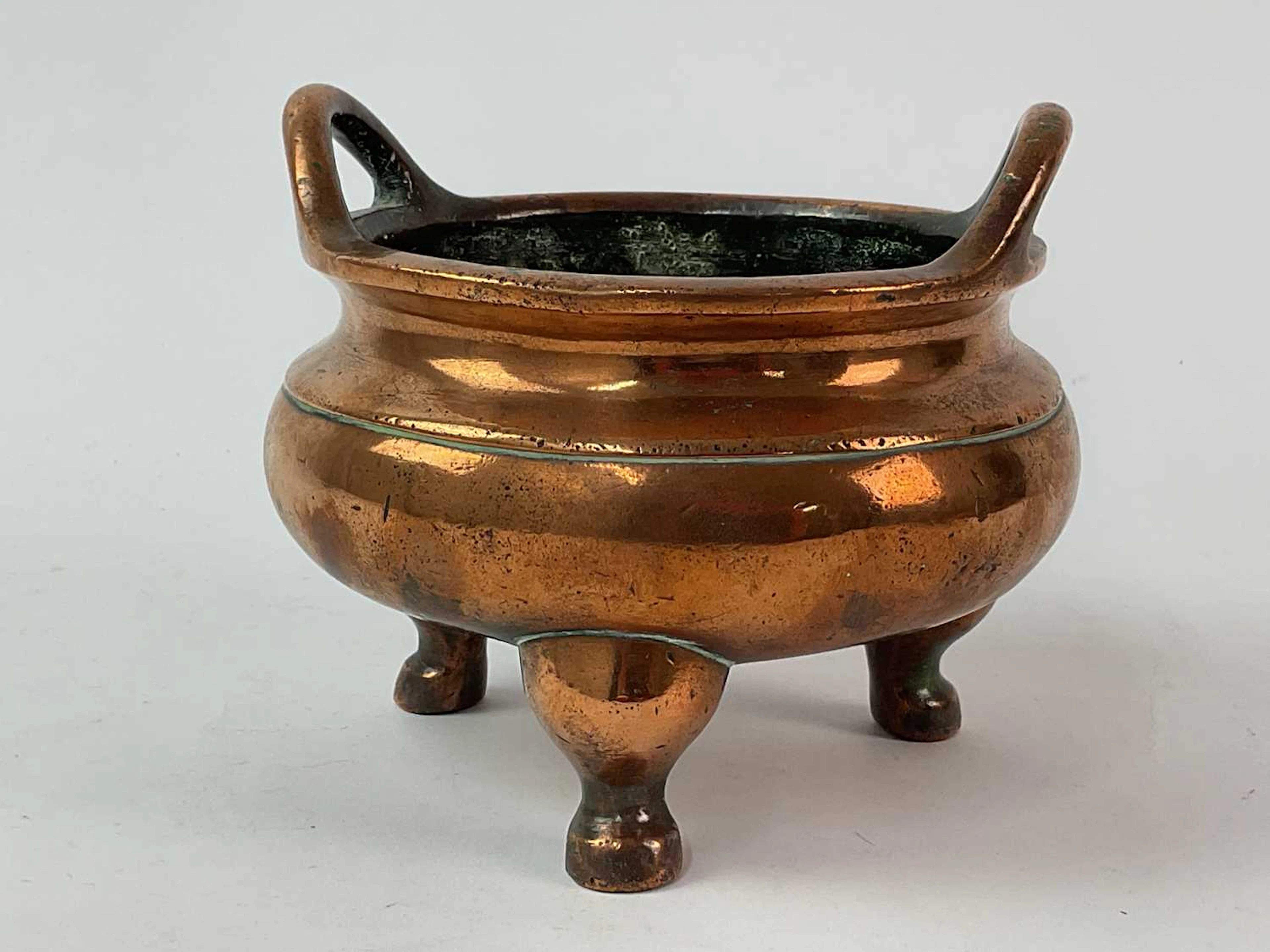 A Chinese bronze tripod censer