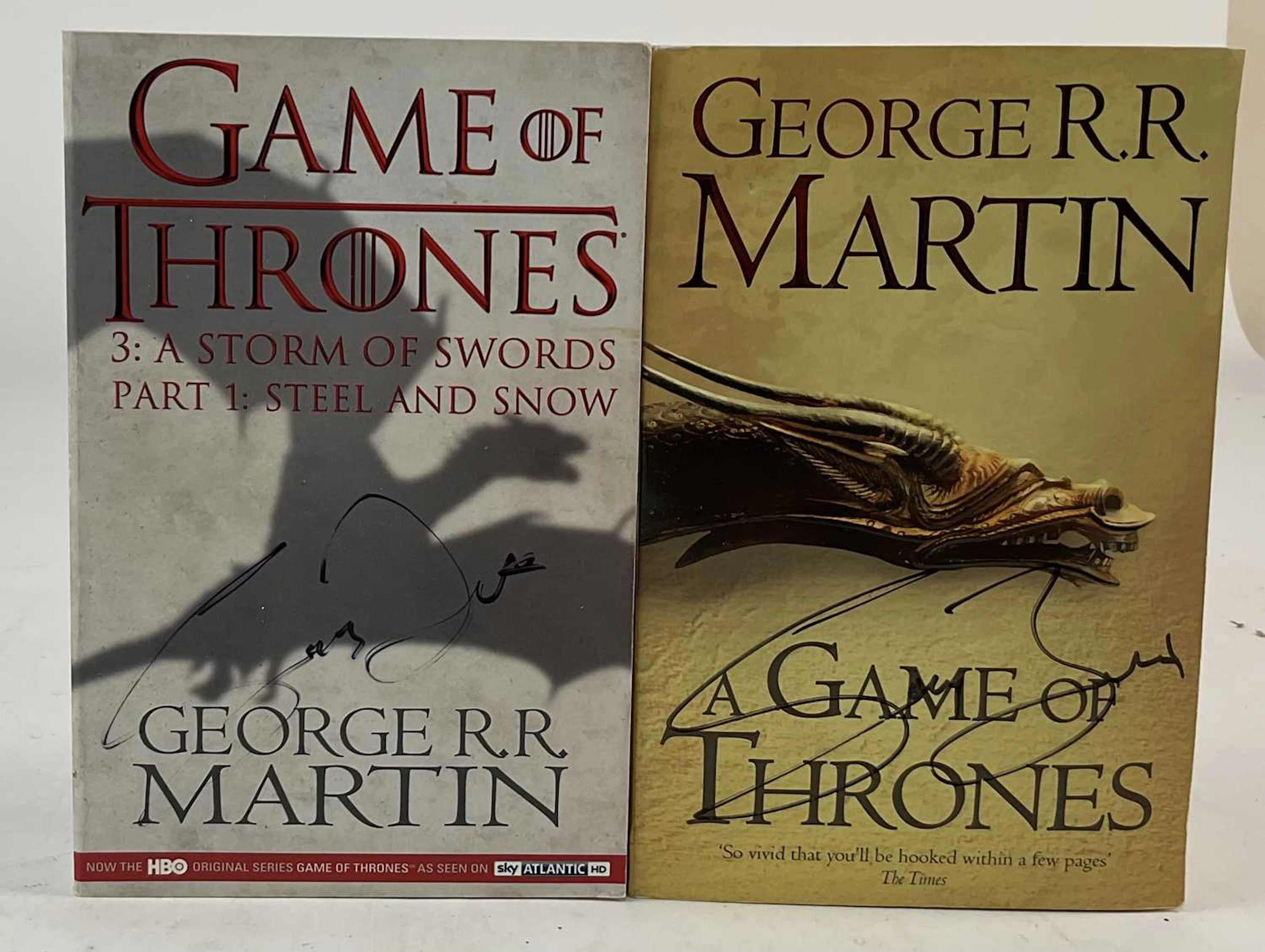 GEORGE R R MARTIN; two 'A Game of Thrones' softback books