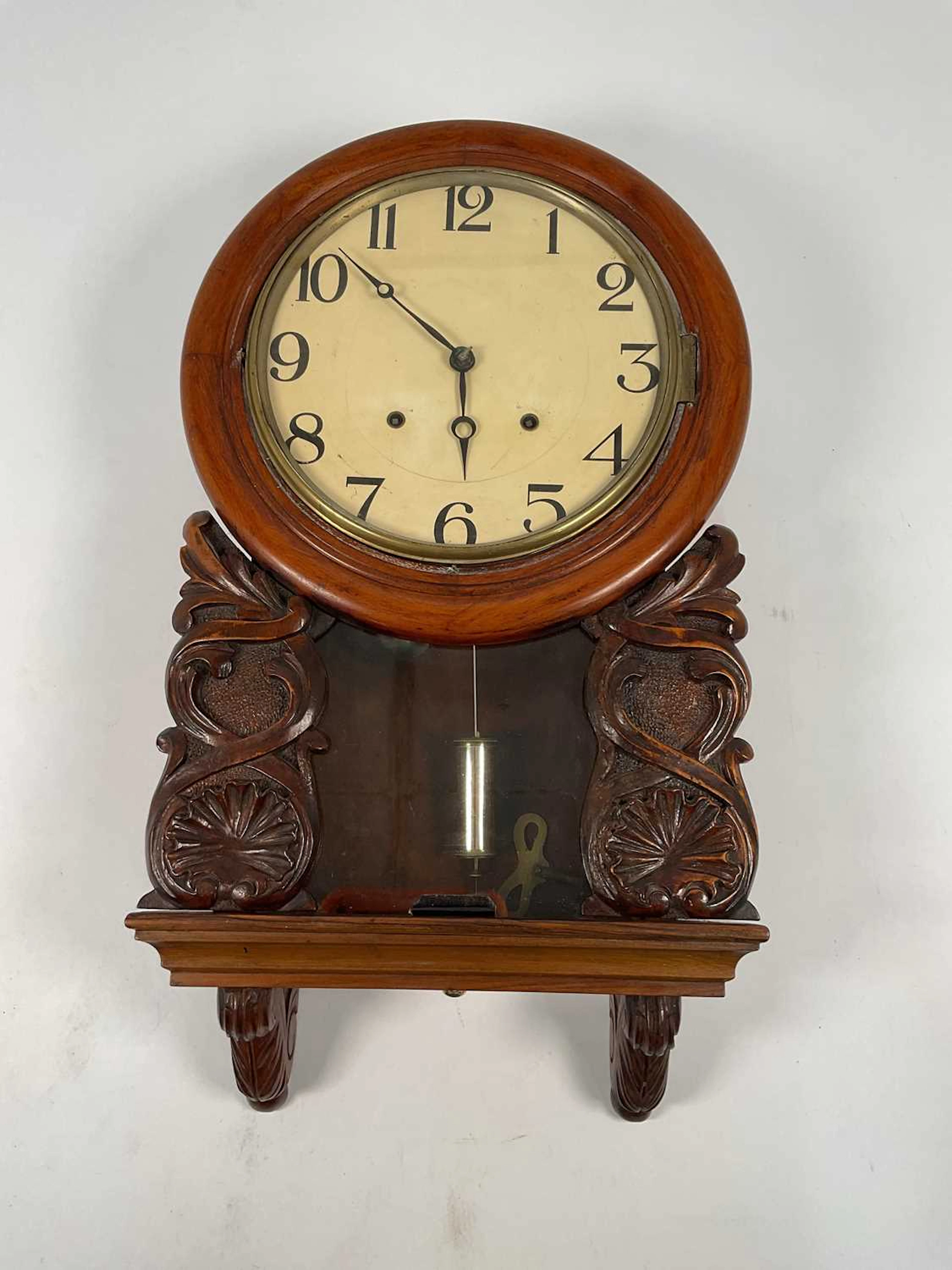 A mahogany wall clock