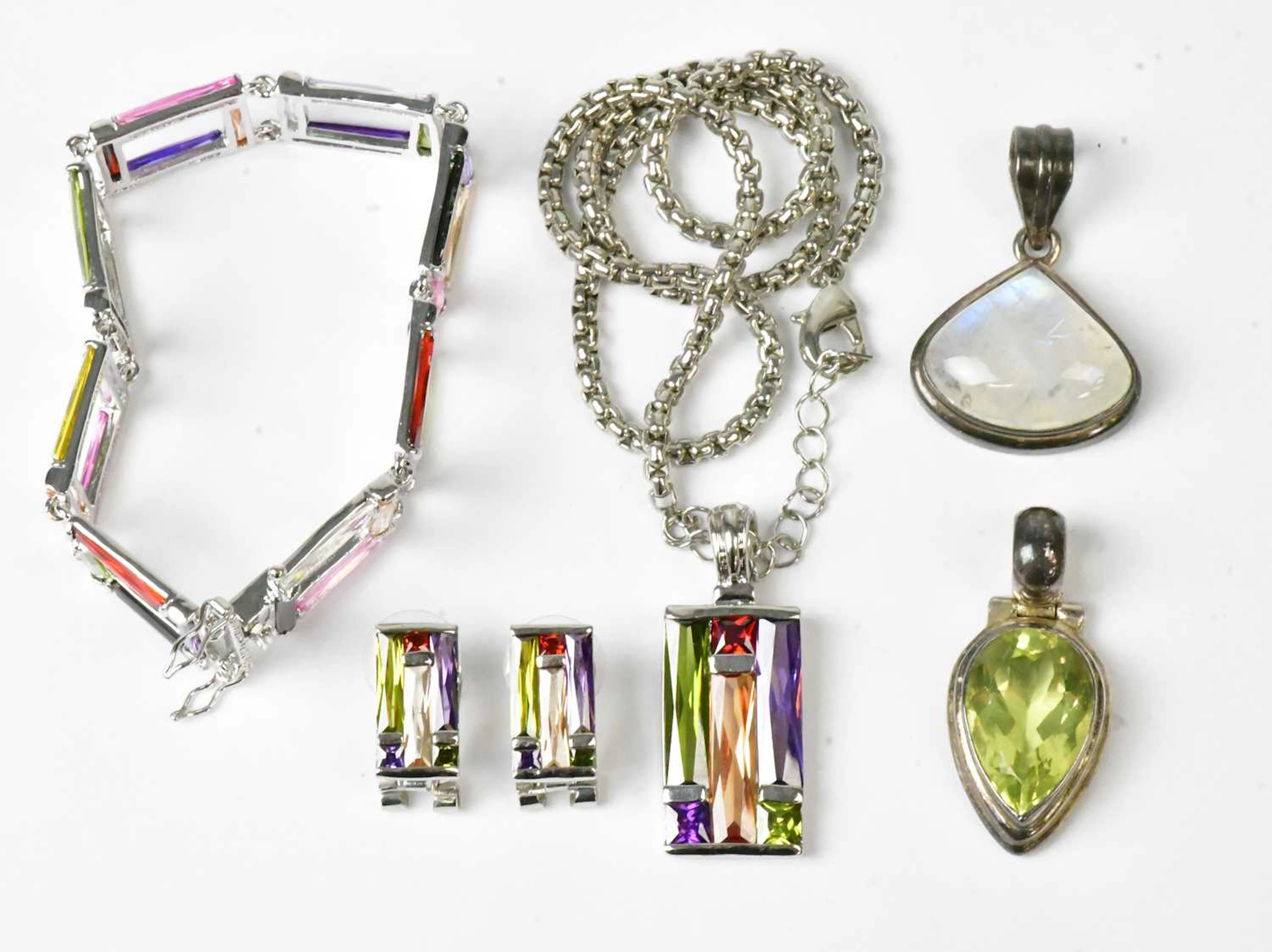 A rectangular pendant set with coloured cabochons