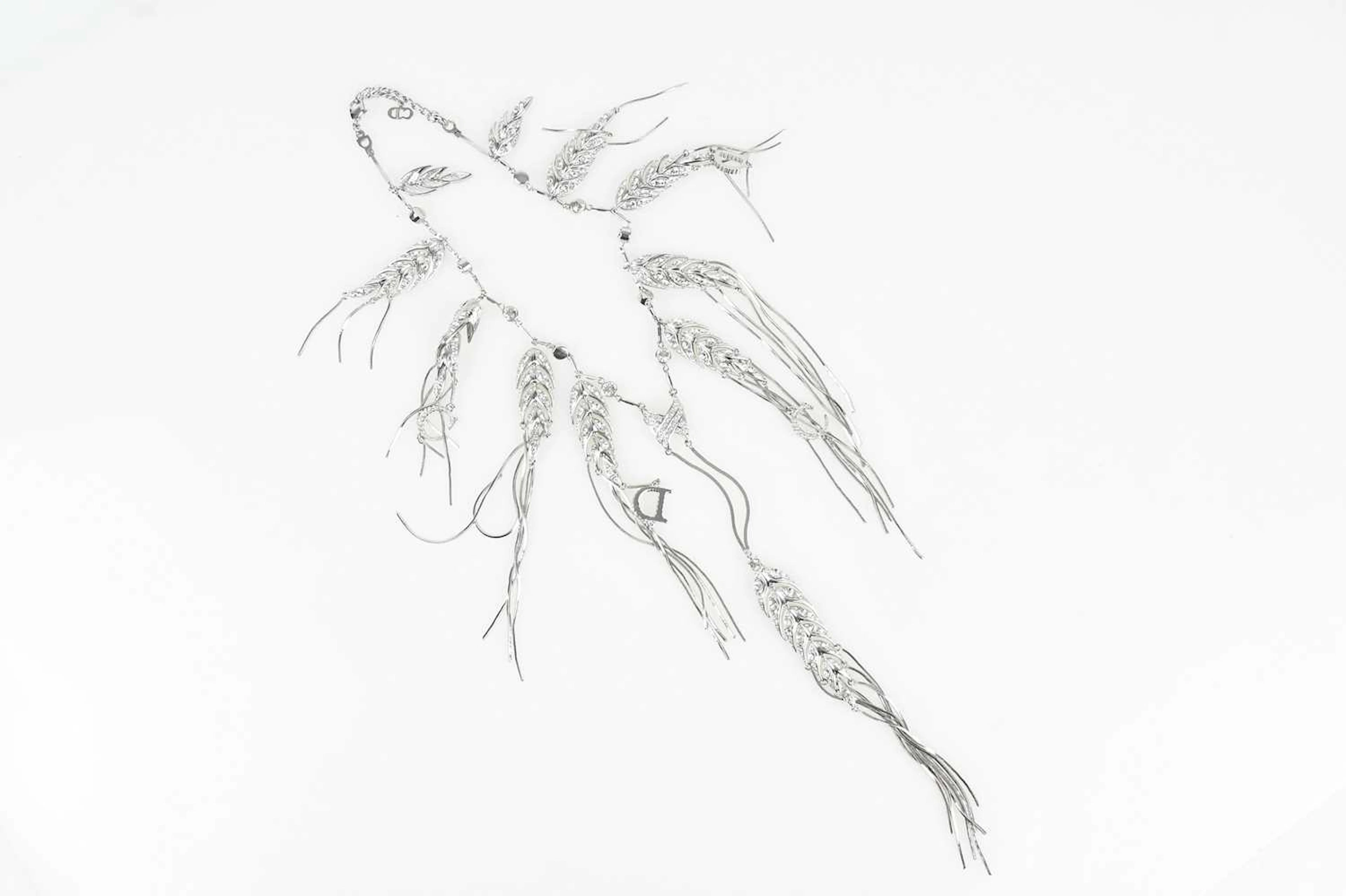 CHRISTIAN DIOR; a silver tone rhodium plated feather...