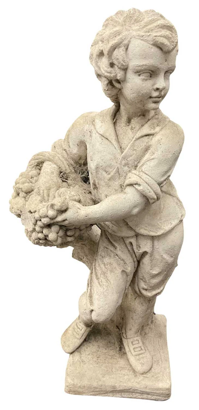 A modern composite stone garden figure of a young boy...
